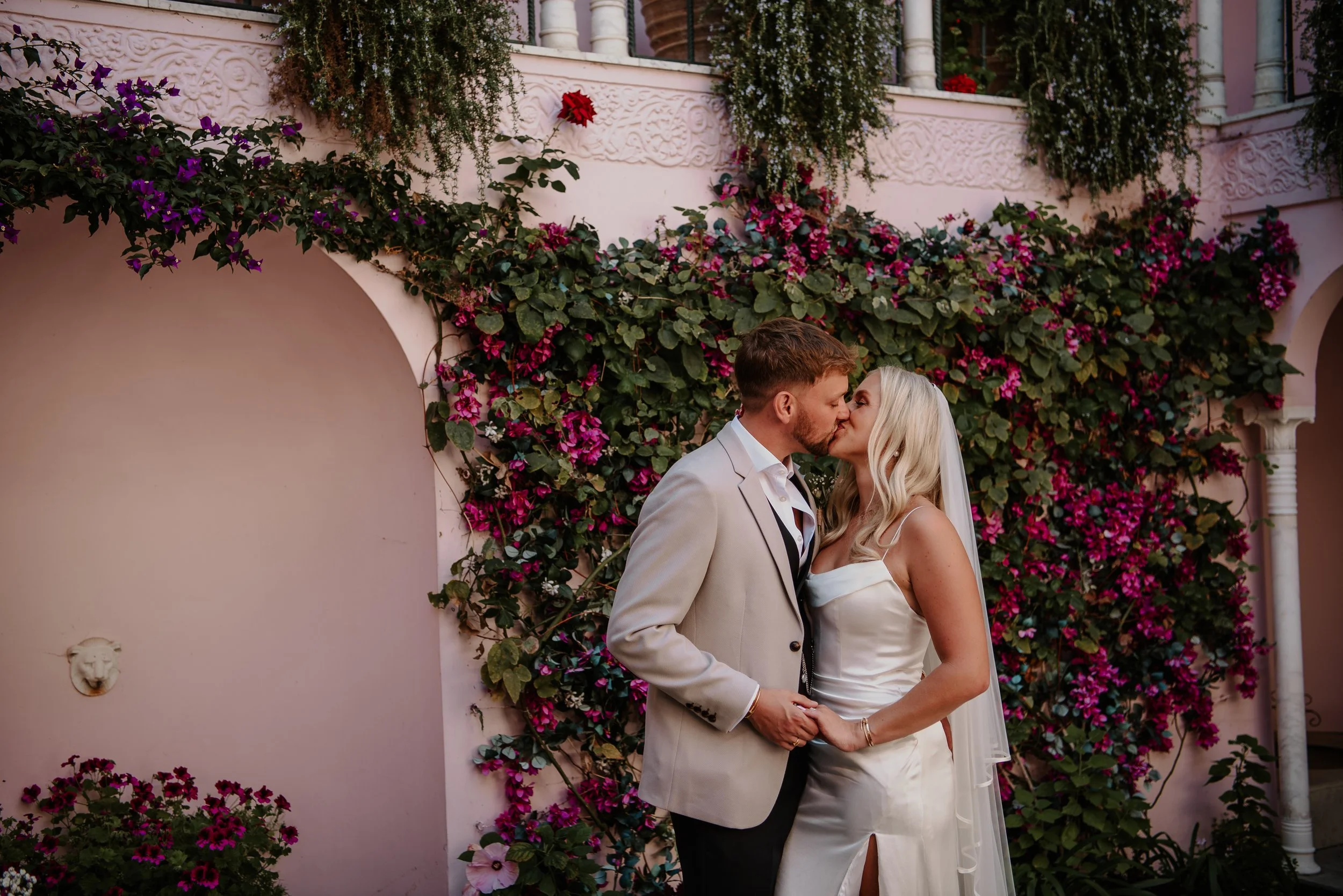 Bride and groom kissing in the Moroccan courtyard at Port Lympne