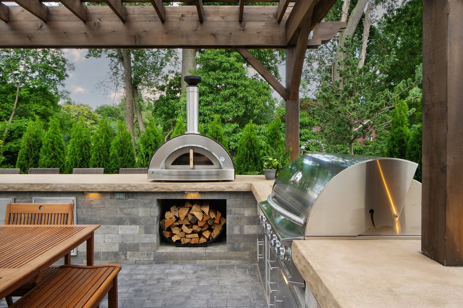 Outdoor kitchen with wood-fired oven and grill