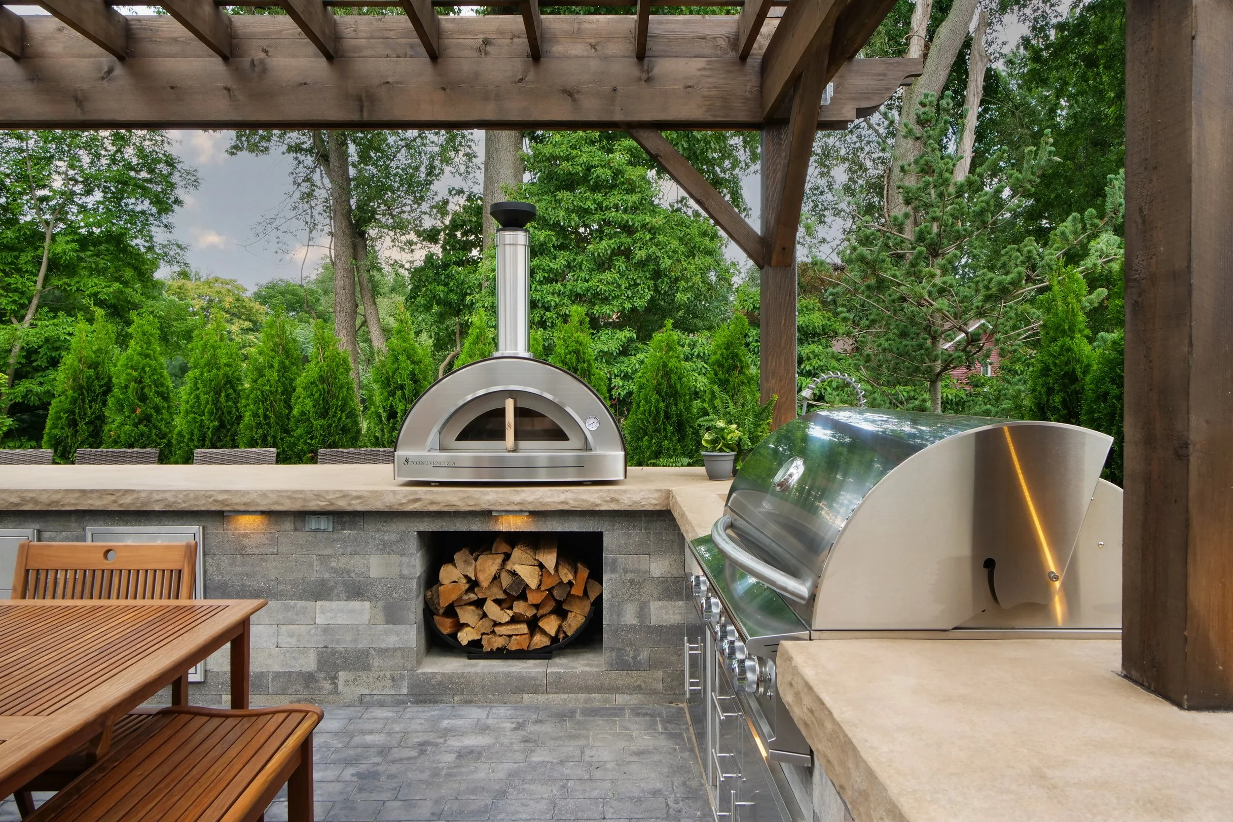 Outdoor kitchen with wood-fired oven and grill