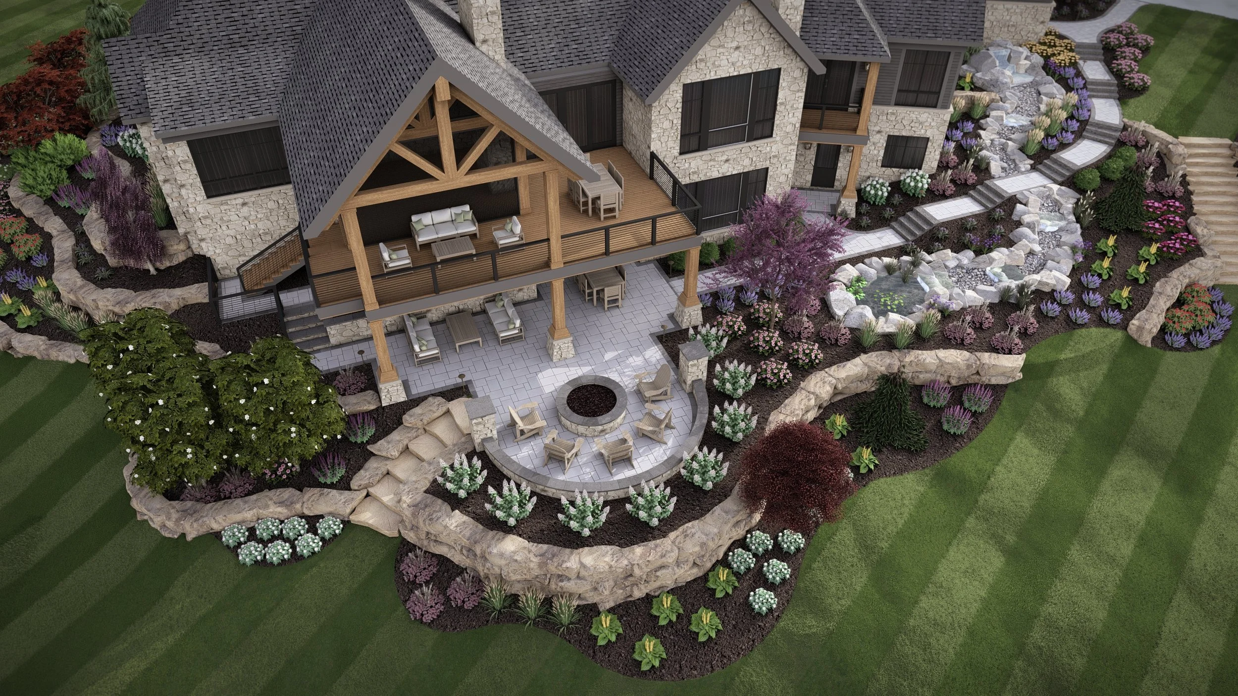 Aerial view of a landscaped backyard with a stone and wood house, patio with seating, fire pit, decorative trees and colorful flower beds, including a water feature and stone steps.