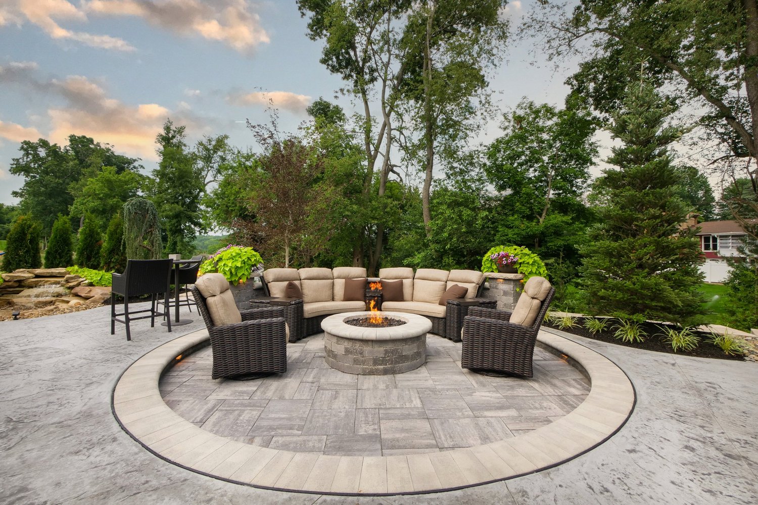 Fireside lounge and paver terrace at dusk