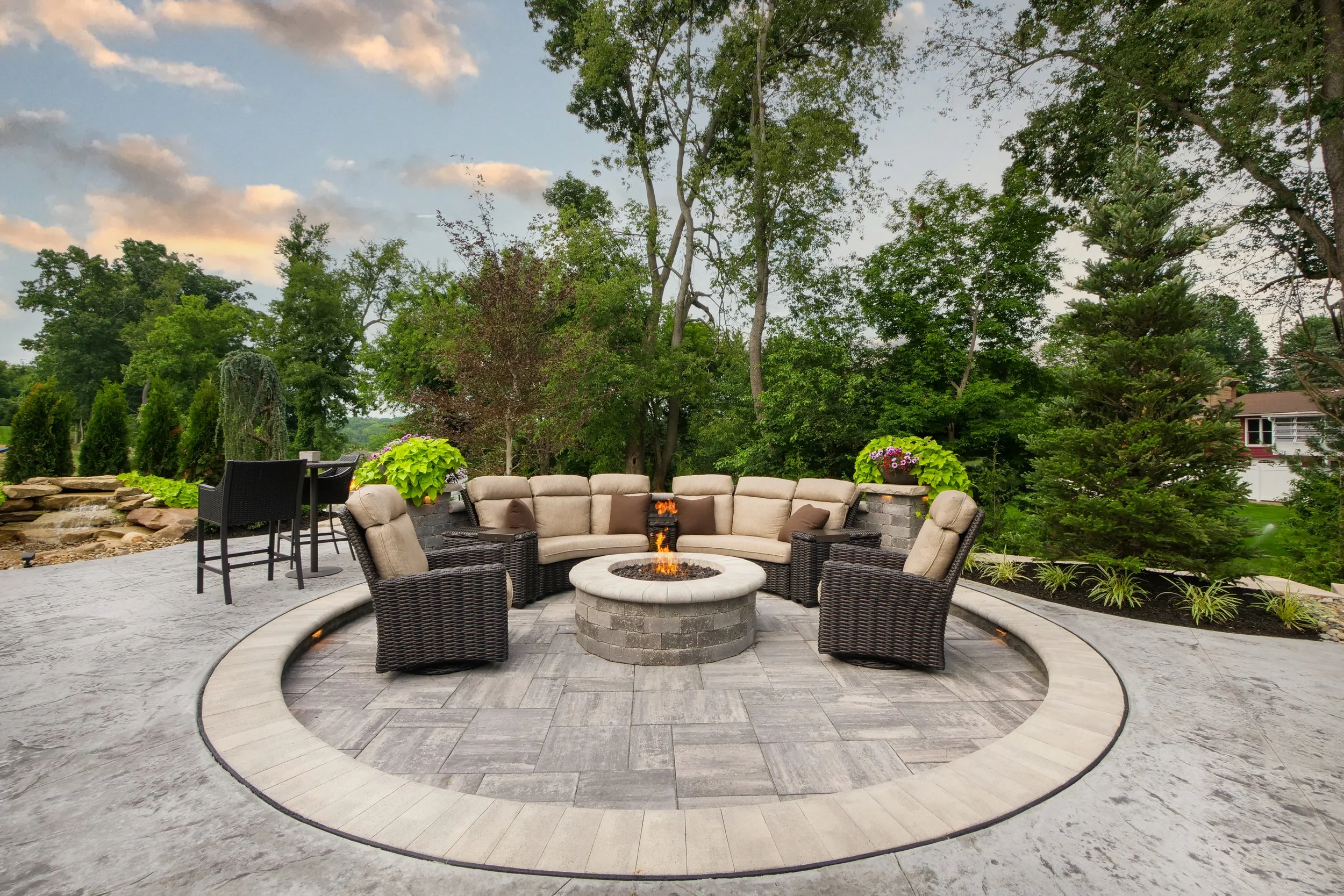 Fireside lounge and paver terrace glowing at dusk