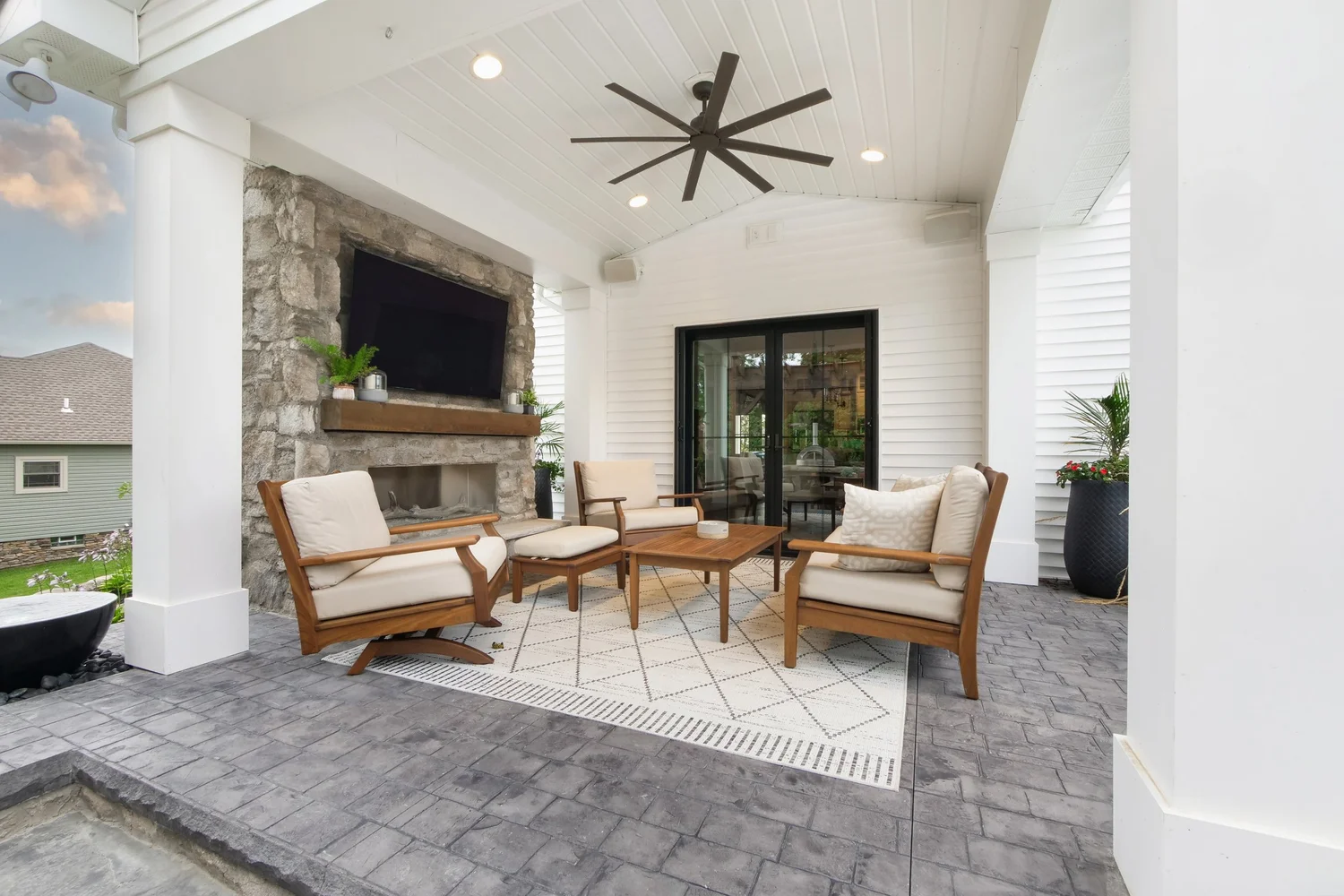 Covered outdoor living room with fireplace