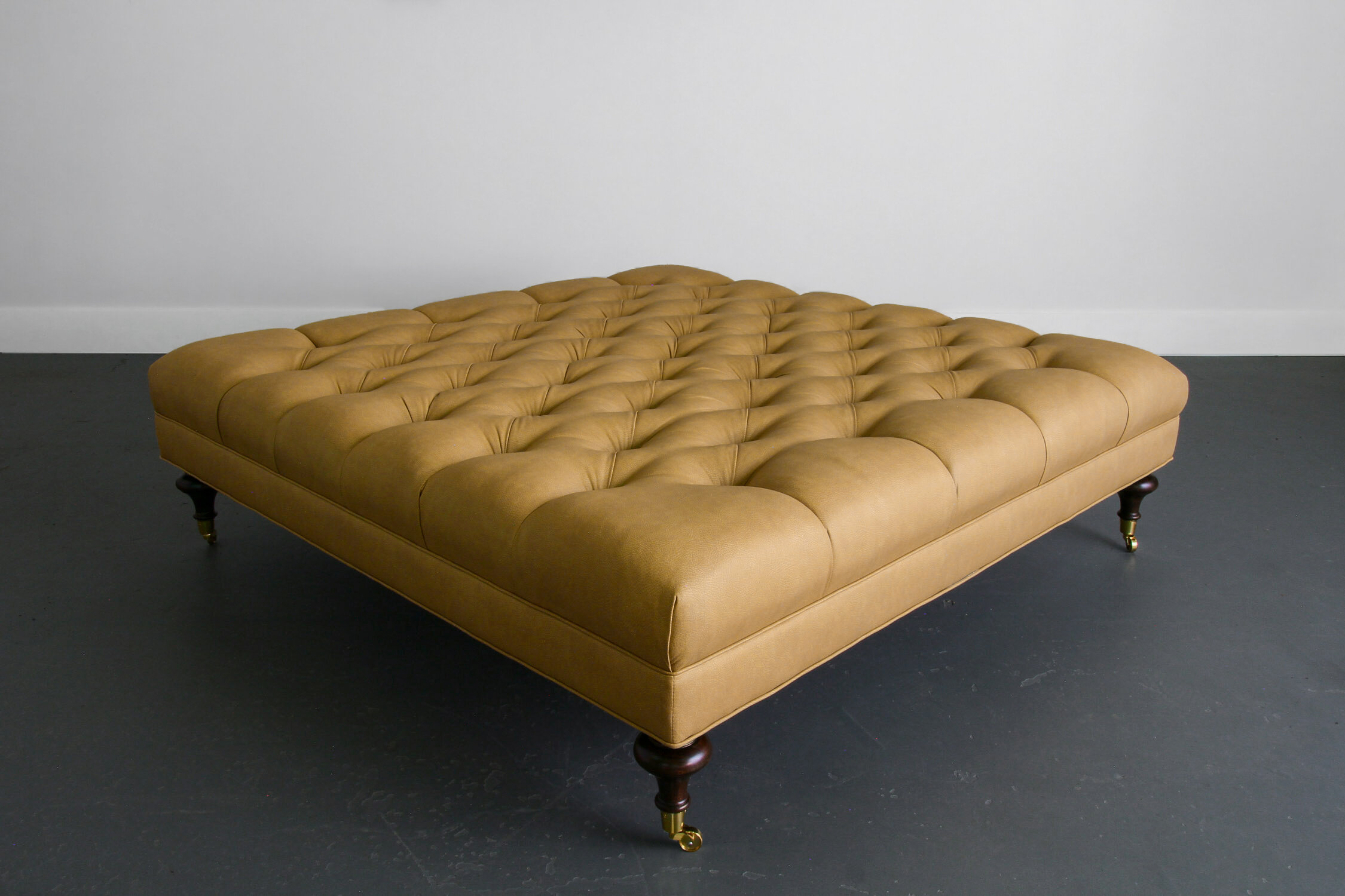 Custom Leather Tufted Ottoman with Turned Wooden Legs on Brass Casters