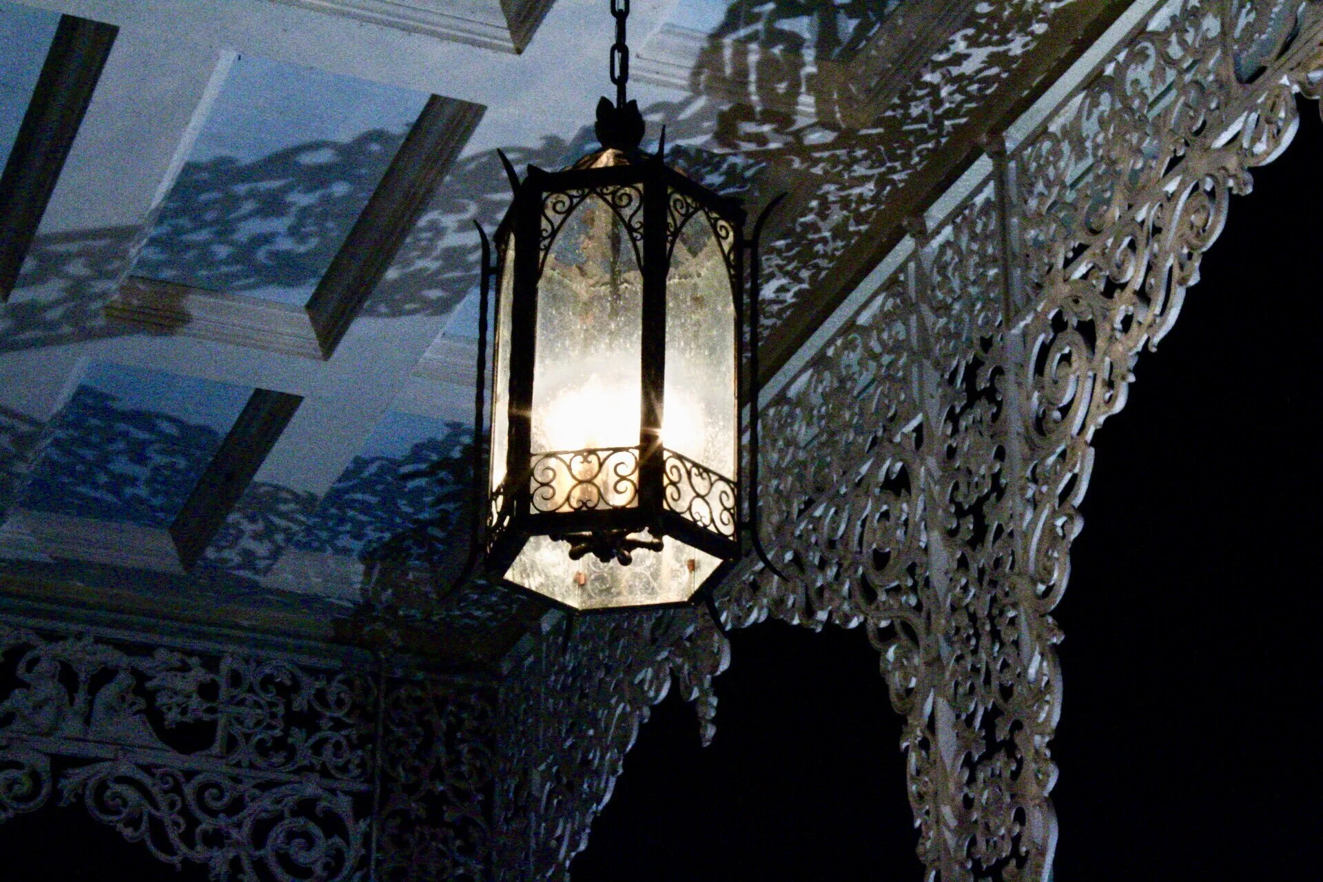 front gallery with light and ironlace on the ceiling reflection.JPG