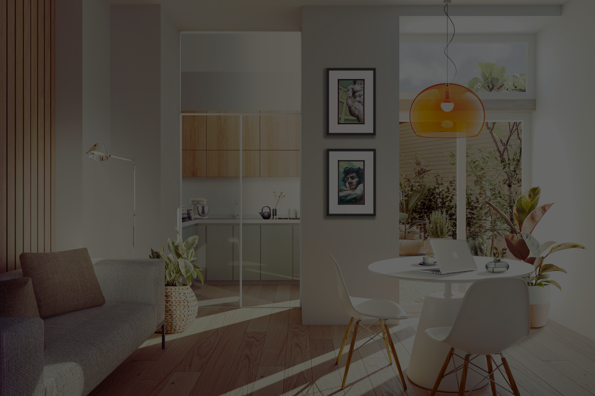 Bright, modern living room and kitchen with natural light, white walls, and wooden flooring. There's a gray sofa, houseplants, a white dining table with chairs, framed artwork on the wall, and a large window.