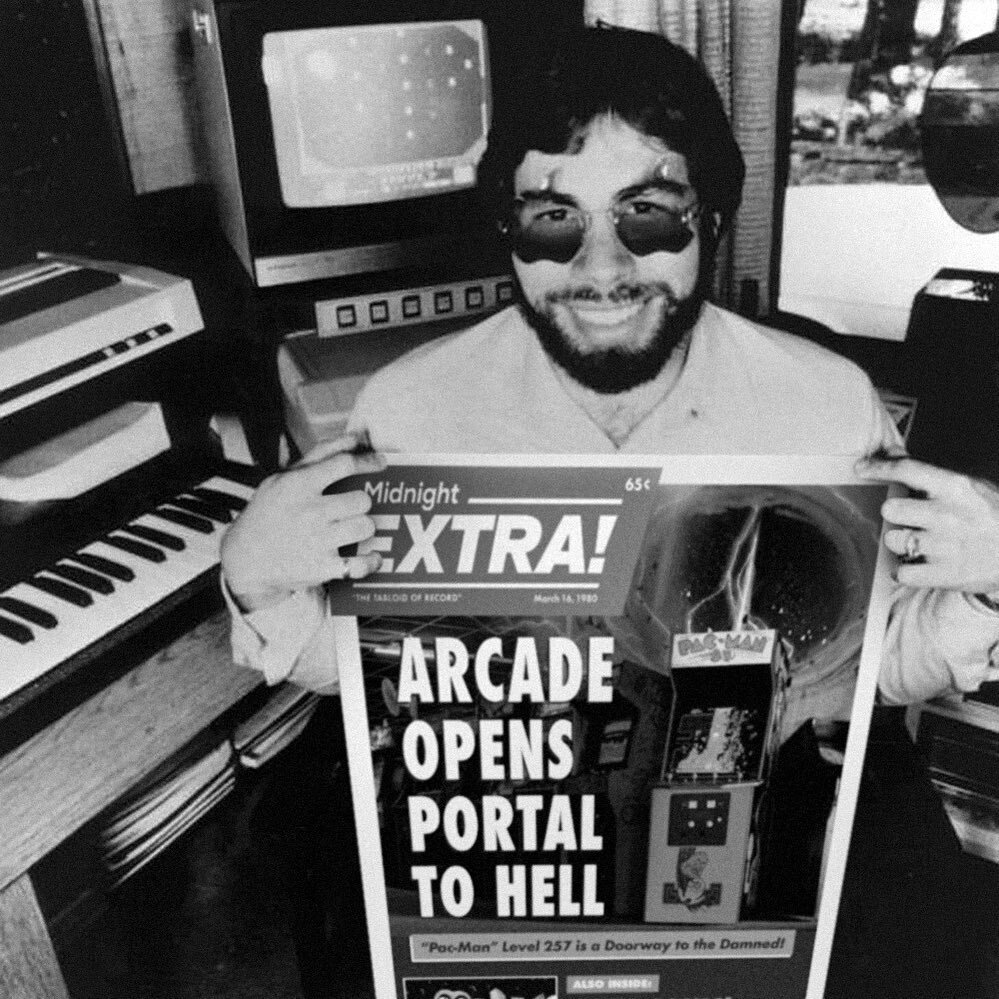 FATHER OF THE PERSONAL COMPUTER (and avid reader of The Midnight Extra!), Steve Wozniak poses with our expos&eacute; on THE DEMONIC DANGERS OF ARCADE GAMES! Little did WOZ know that his early circuit boards would pave the way to PORTALS OF THE DAMNED