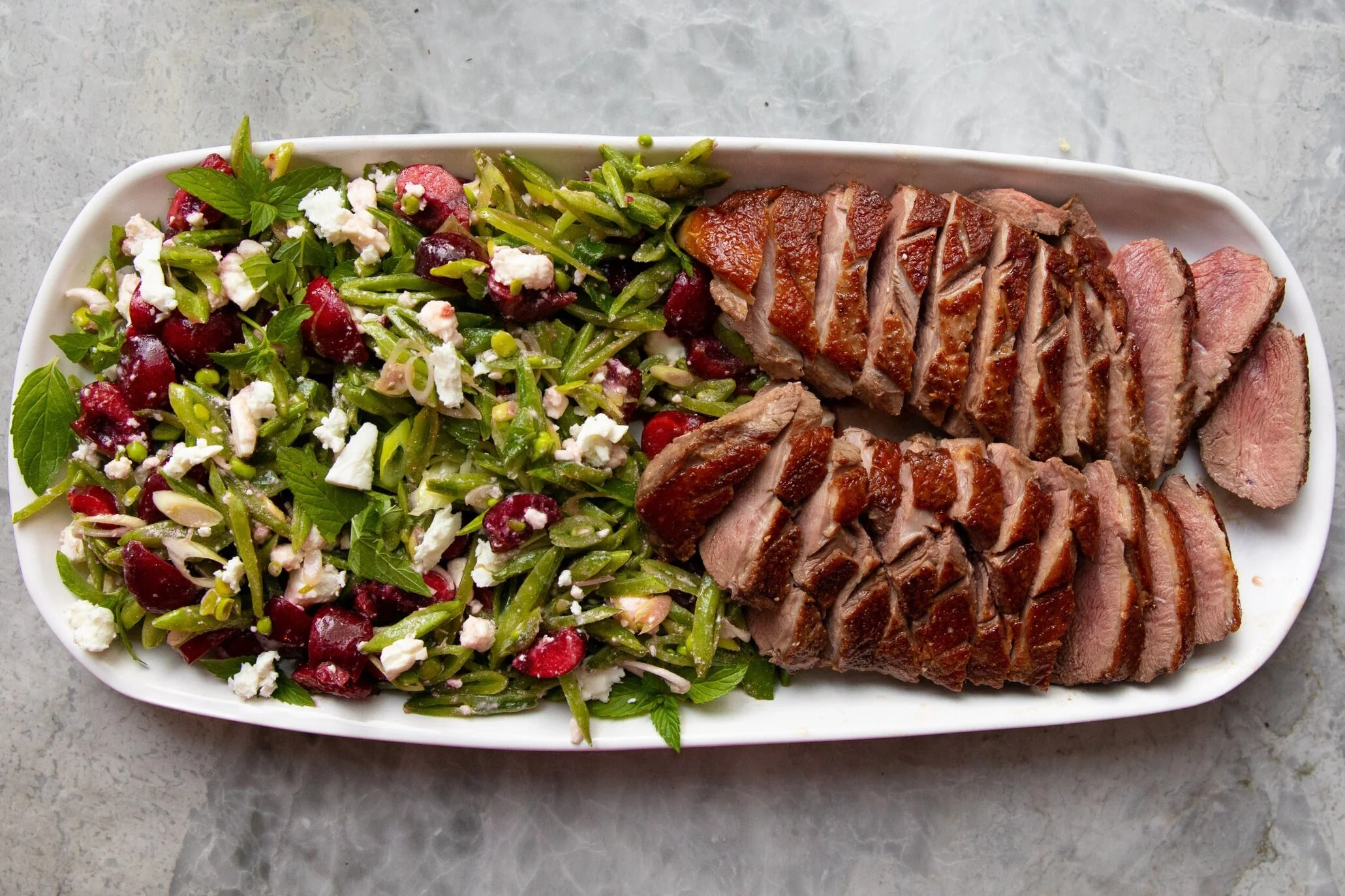 Sweet, salty, minty salad functions as both salad and sauce for seared duck breast