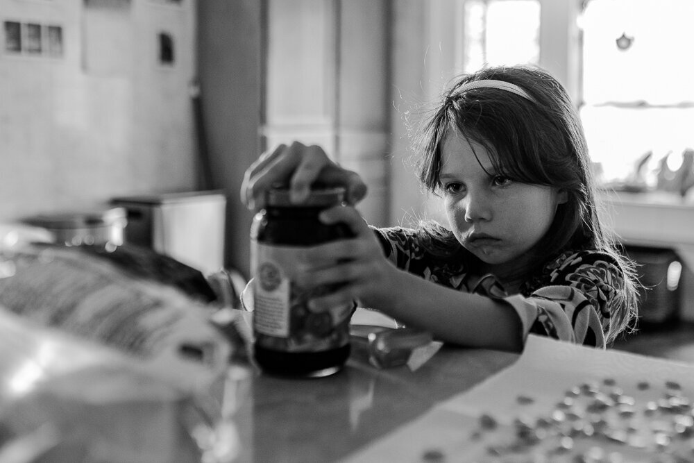  Lucia Hampton (6) struggles to open a jar of jelly to make herself an after school snack, at her home in Mecosta, Michi. on Sept. 17, 2021. 