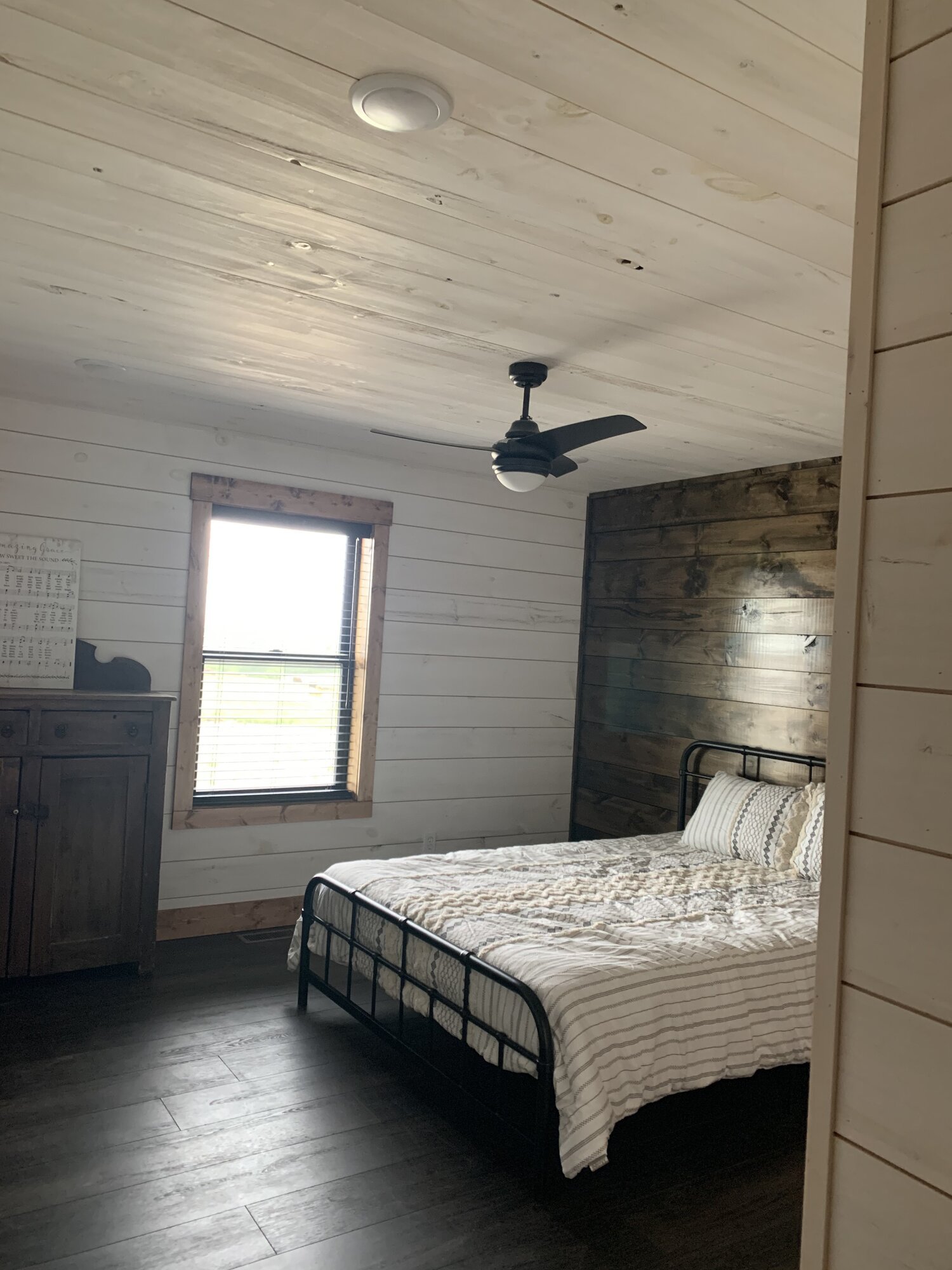  How about their “whitewashed” shiplap walls? It’s an interesting technique we hadn’t heard of. When asked, she explained that to get the same look one must “Spray the paint (not watered down) on, and wipe down with floor finishing pads.” As you can 