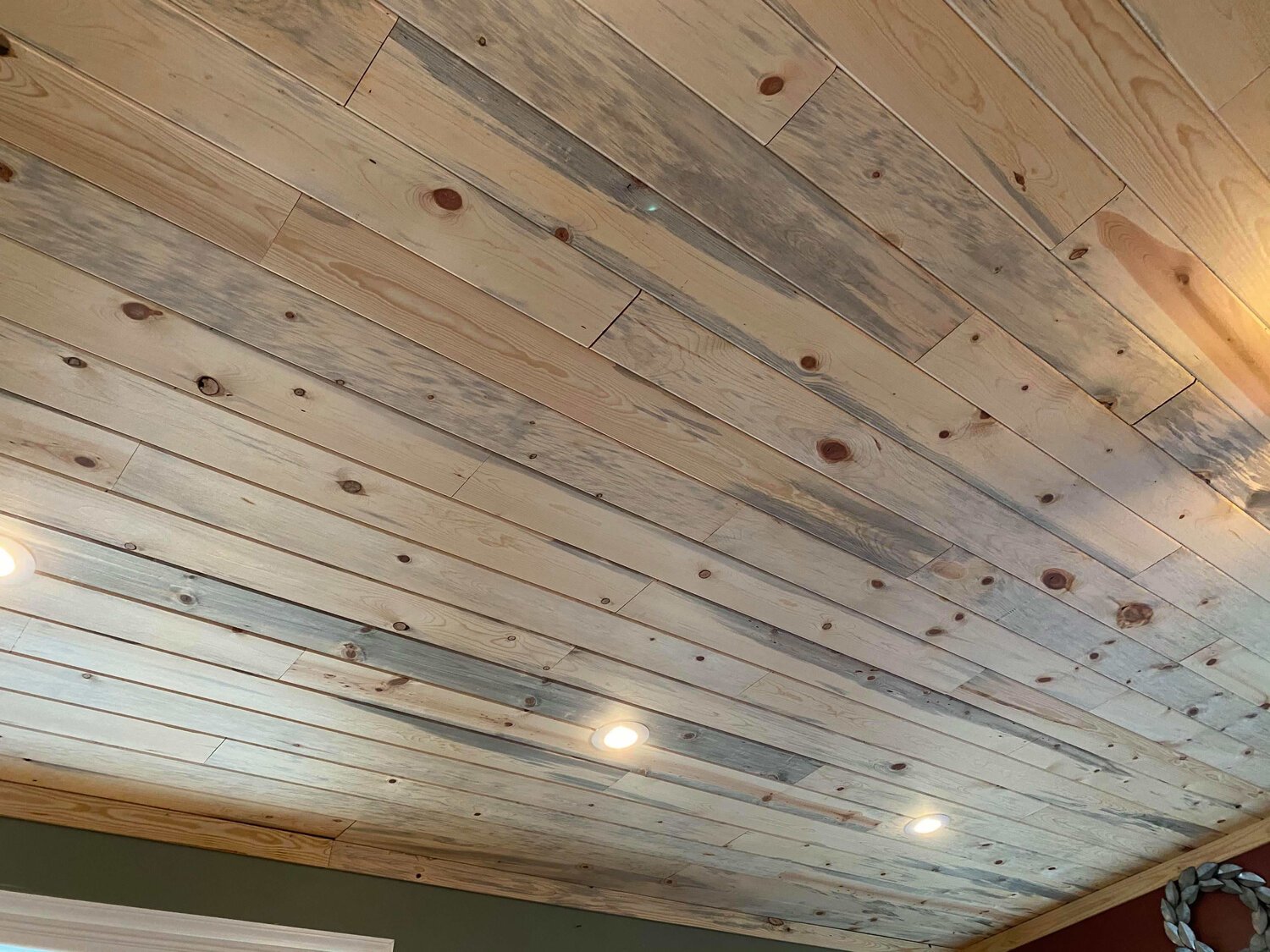   Full of creativity and outside-the-box ideas (we love the way you think Henry!), they decided to not only install the blue stain pine on their living room ceiling, but also on the floors. They even built a door from their&nbsp;waste pile.  