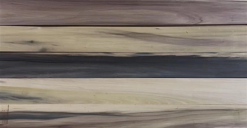 Rainbow poplar boards laid out together showing natural variation in color and grain.