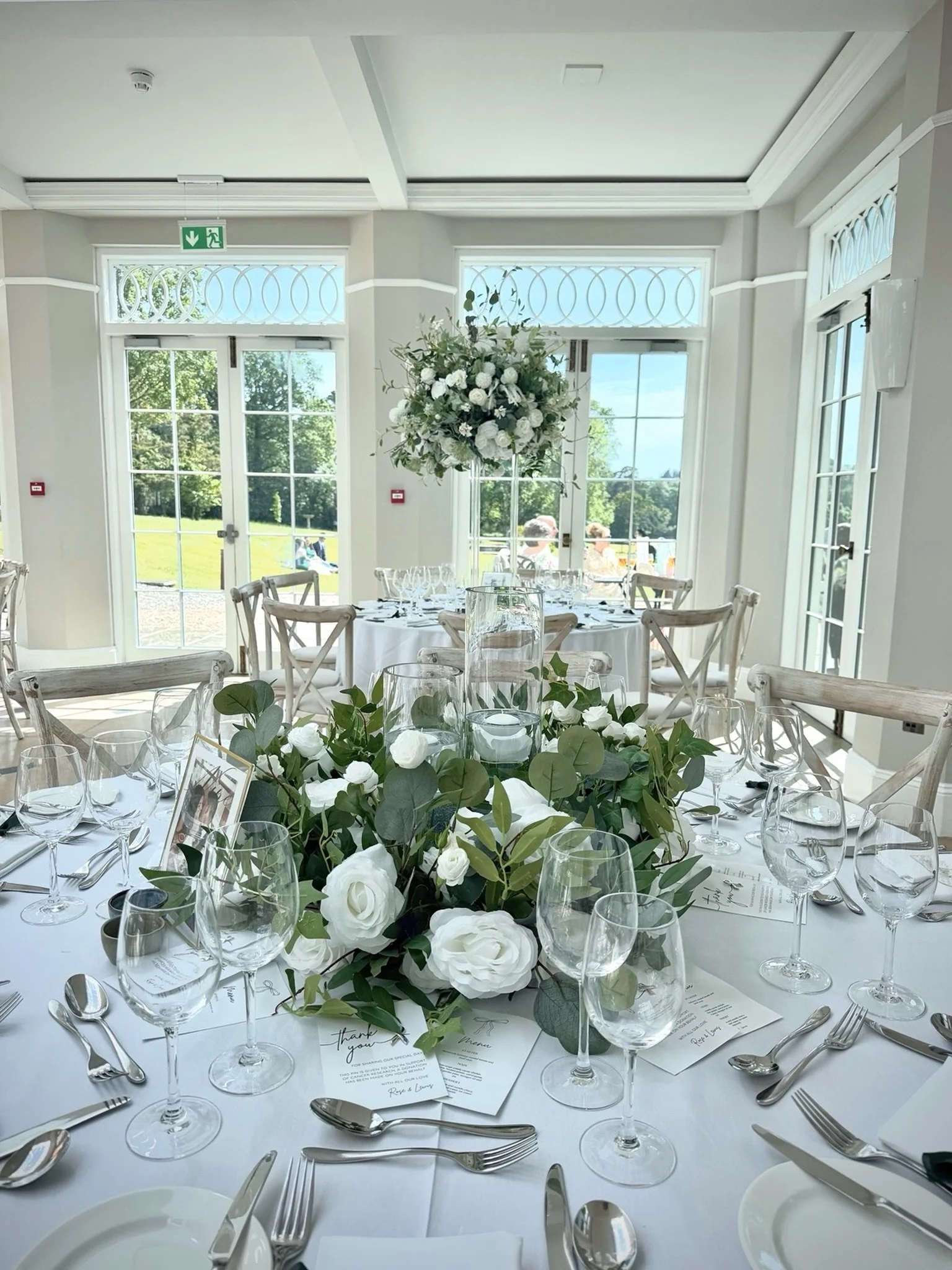 Considering high and low centrepieces?

Combining statement elevated centrepieces with lower floral arrangements is a beautiful way to add height, interest and balance to your wedding reception.

Here, timeless foliage and rose and soft candlelight c