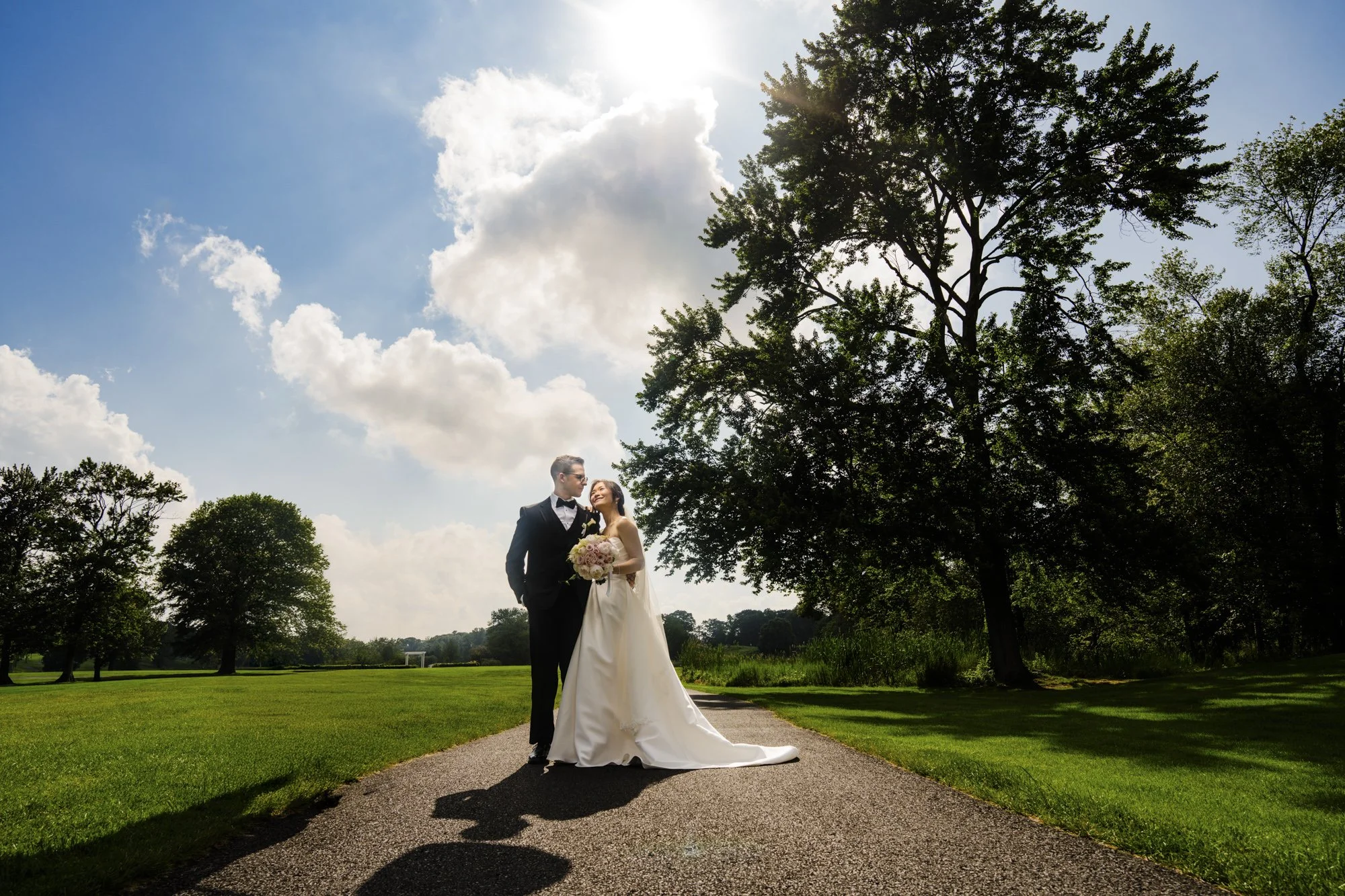 Wedding couple on a path beside the green fairways at Galloping Hill