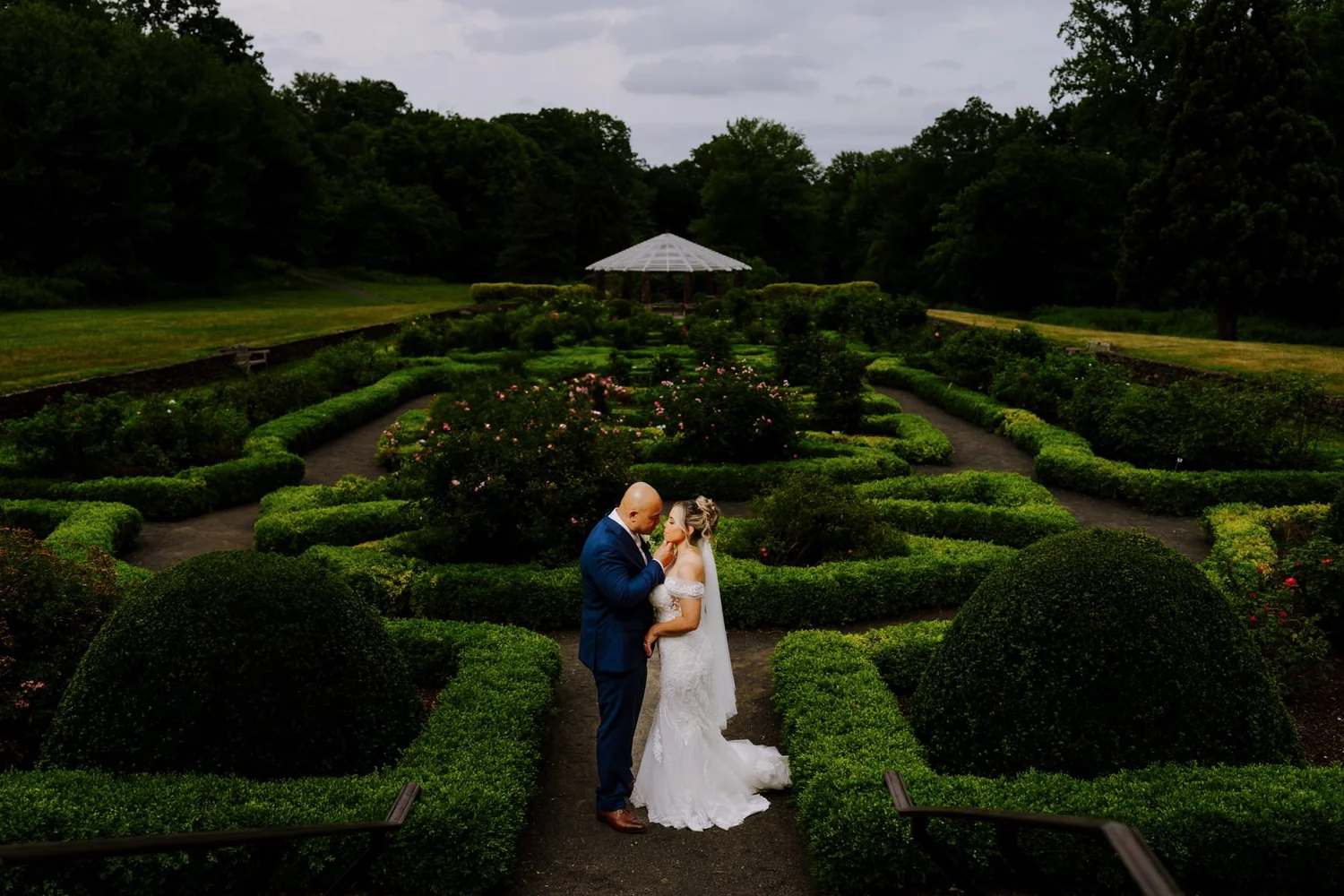Newlyweds standing together in a garden