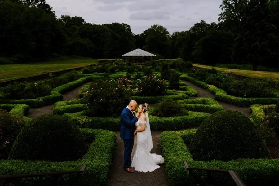 A Delgado Studios couple together in a formal garden