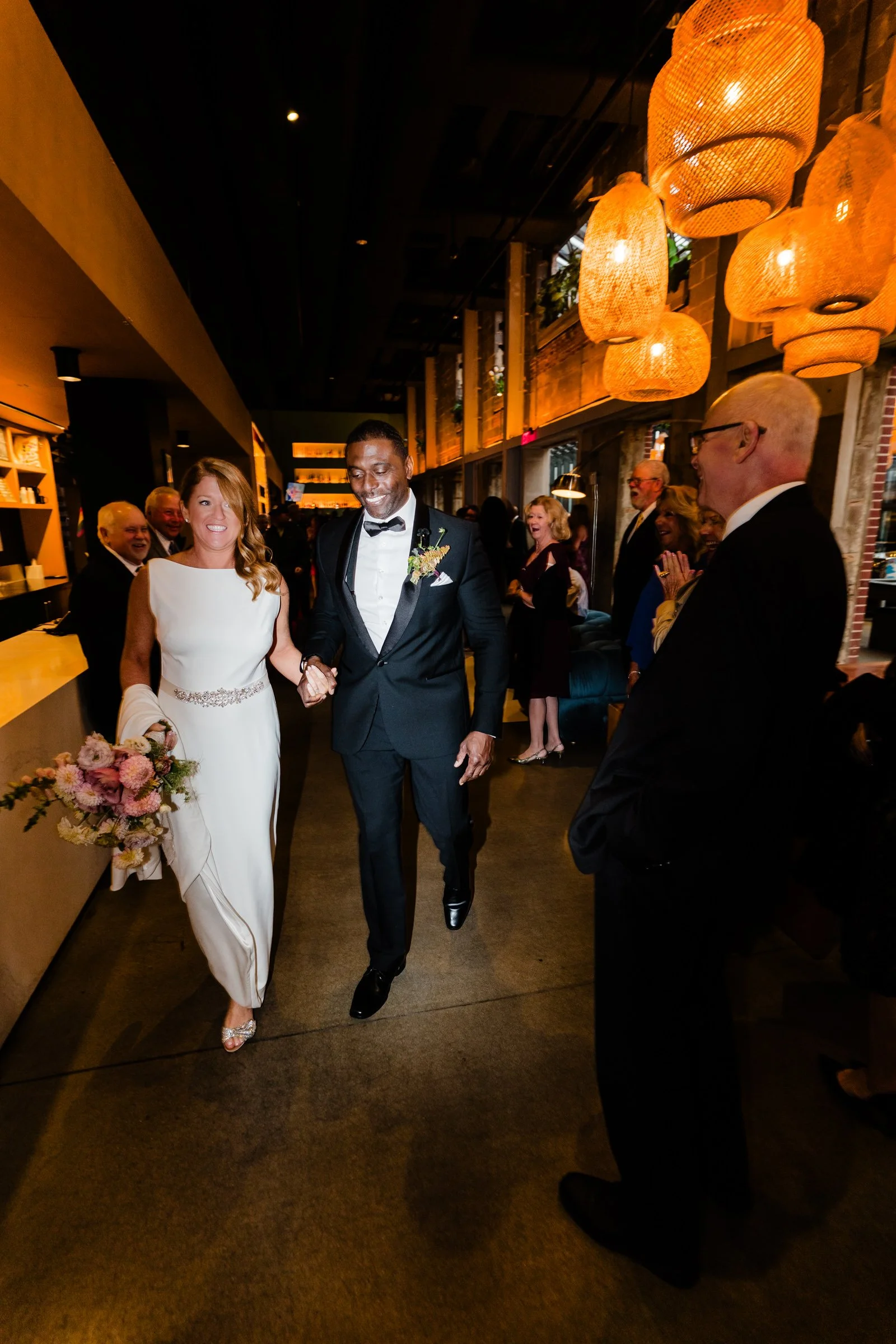 Bride and groom entering their wedding reception