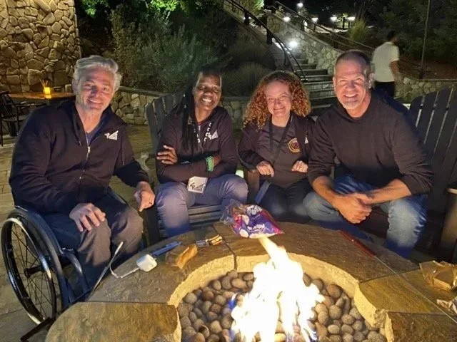 Athletes’ Voices retreat participants around the fire pit