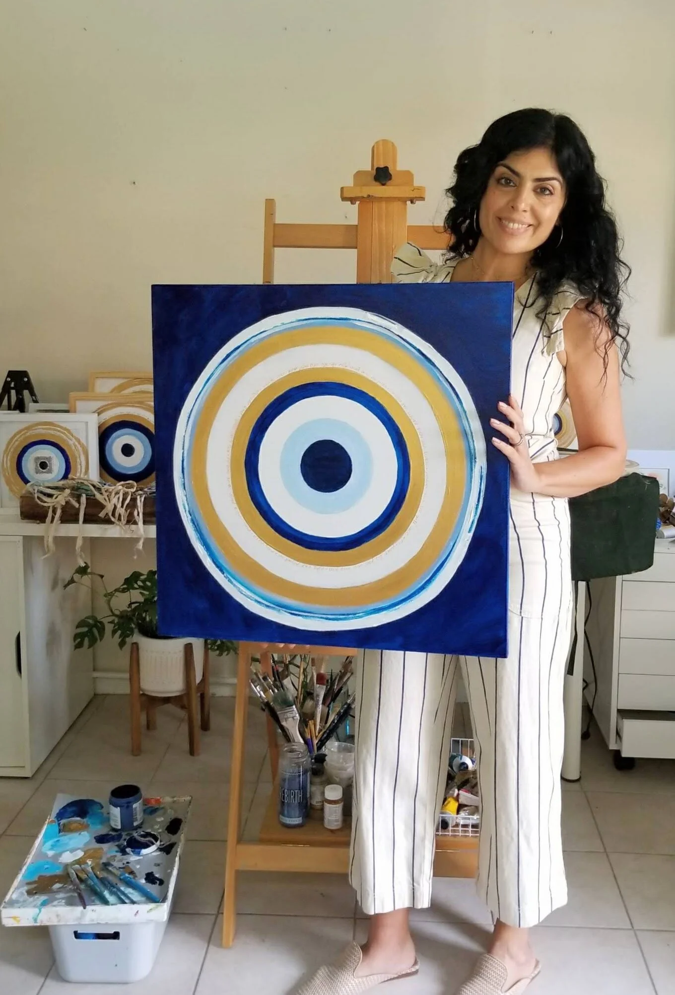 TAMMY IN STUDIO WITH BLUE CANVAS.jpg