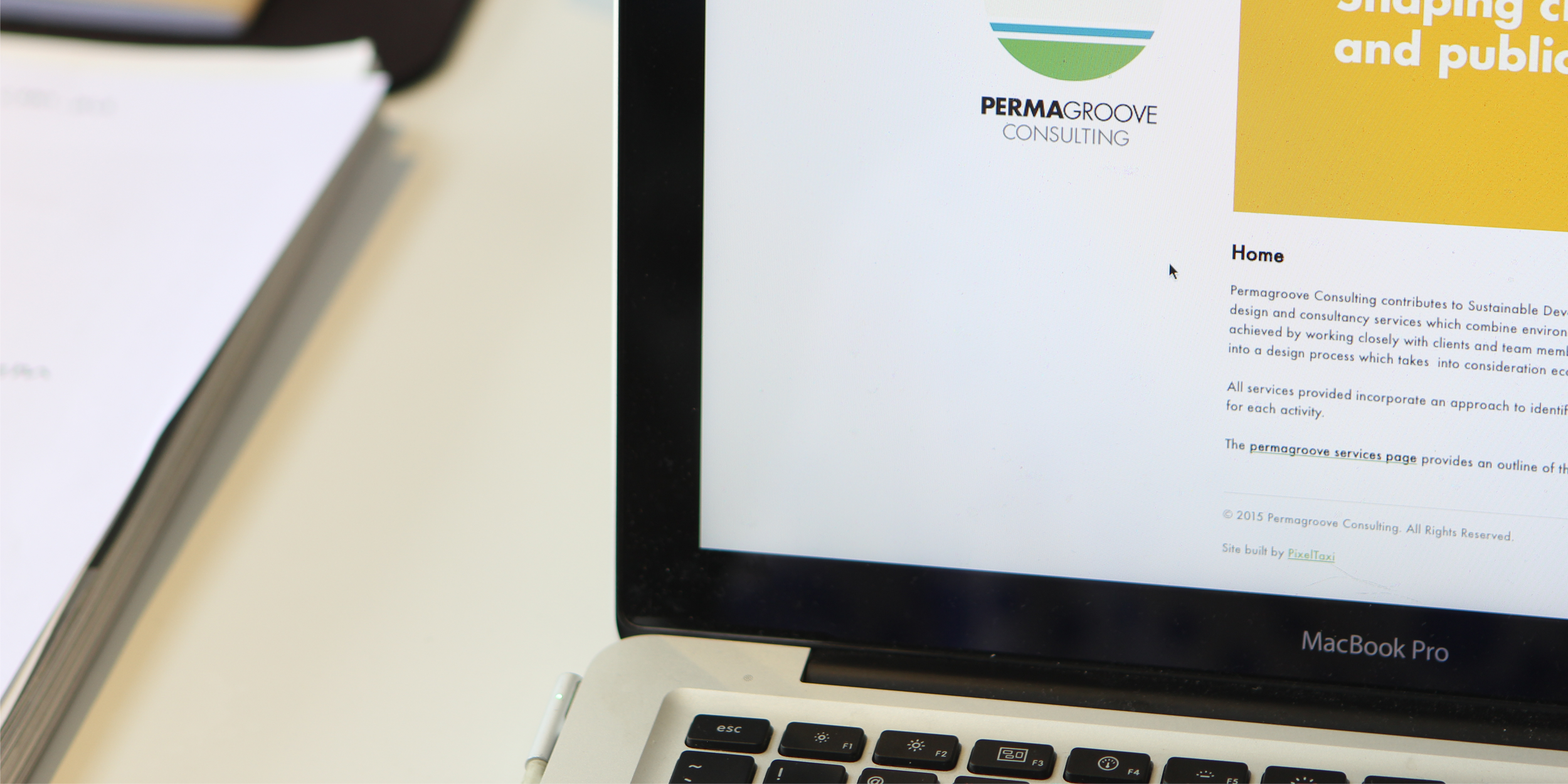 Left part of a laptop screen showing a logo of Perma Groove and a part of the website page