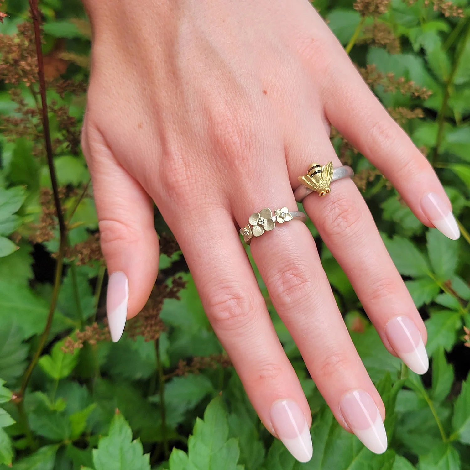 Large Bee Ring. 14k yellow gold, amber diamonds, black diamonds, silver. Shown here on white female model. Handmade fine art jewelry by Rebecca Myers Design.