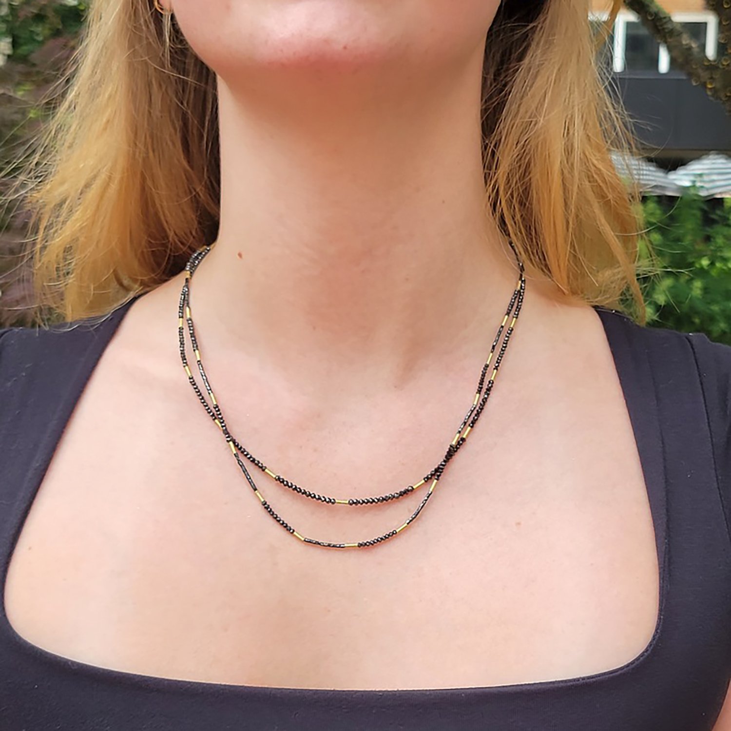 Black Diamond and Gold Bead Necklaces. Shown here on white female model. Handmade fine art jewelry by Rebecca Myers Design.