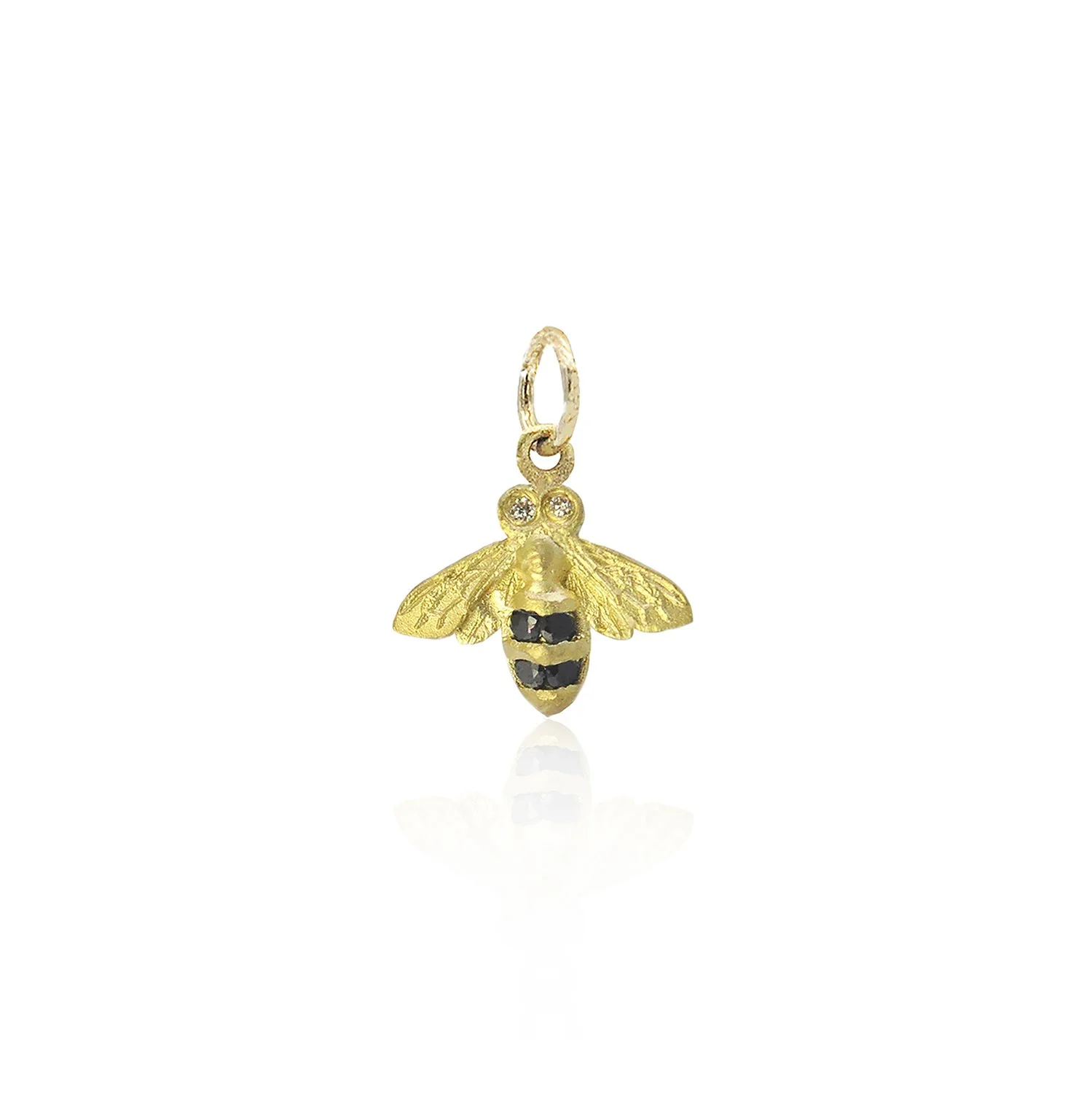 18k yellow gold bee with black diamond stripes and white diamond eyes. On white background. Handmade fine art jewelry by Rebecca Myers Design.