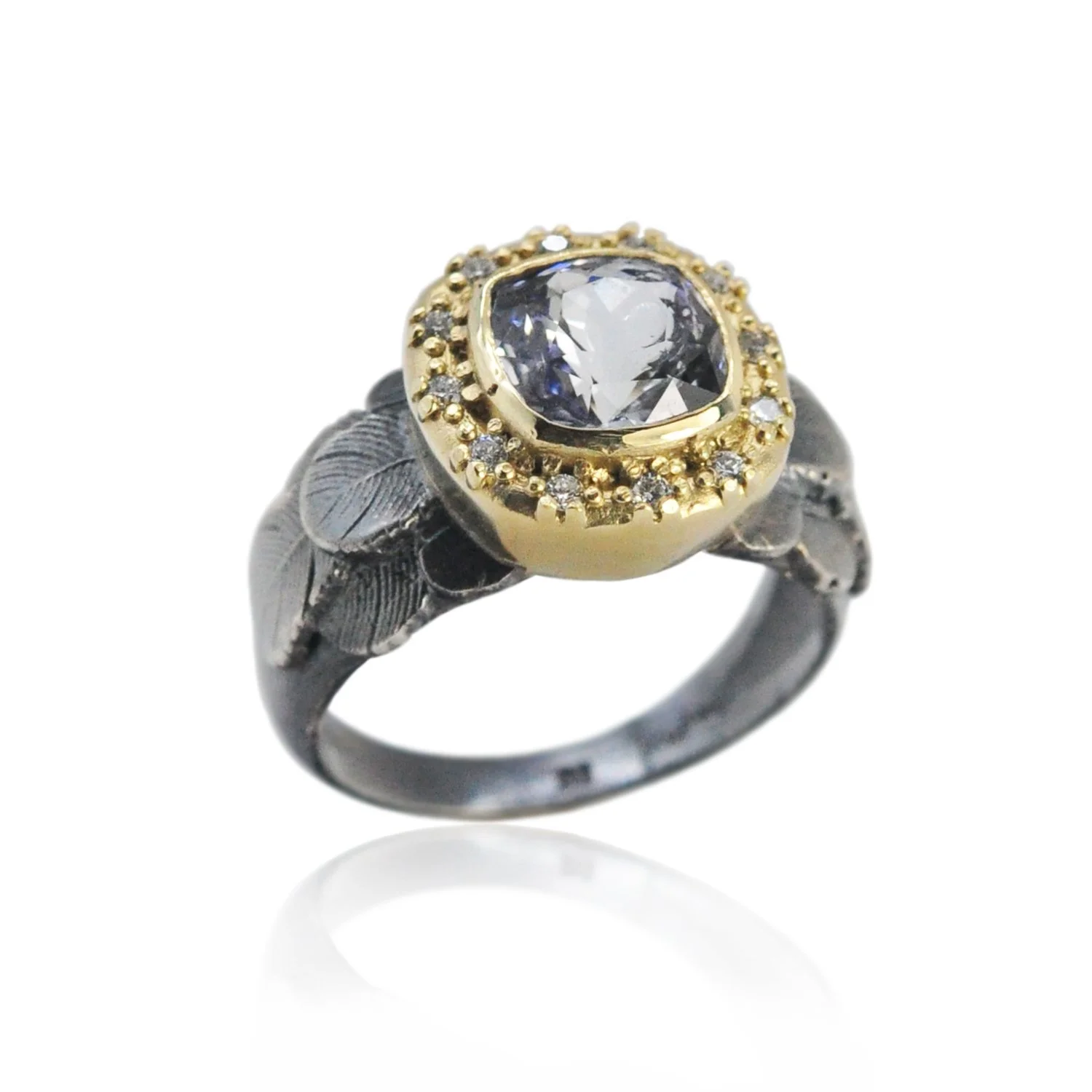 Feather Halo Ring with Cushion Cut Lavender Sapphire. Cushion cut lavender sapphire, 14k yellow gold, oxidized silver, pave set white diamonds. Handmade fine art jewelry by Rebecca Myers Design.