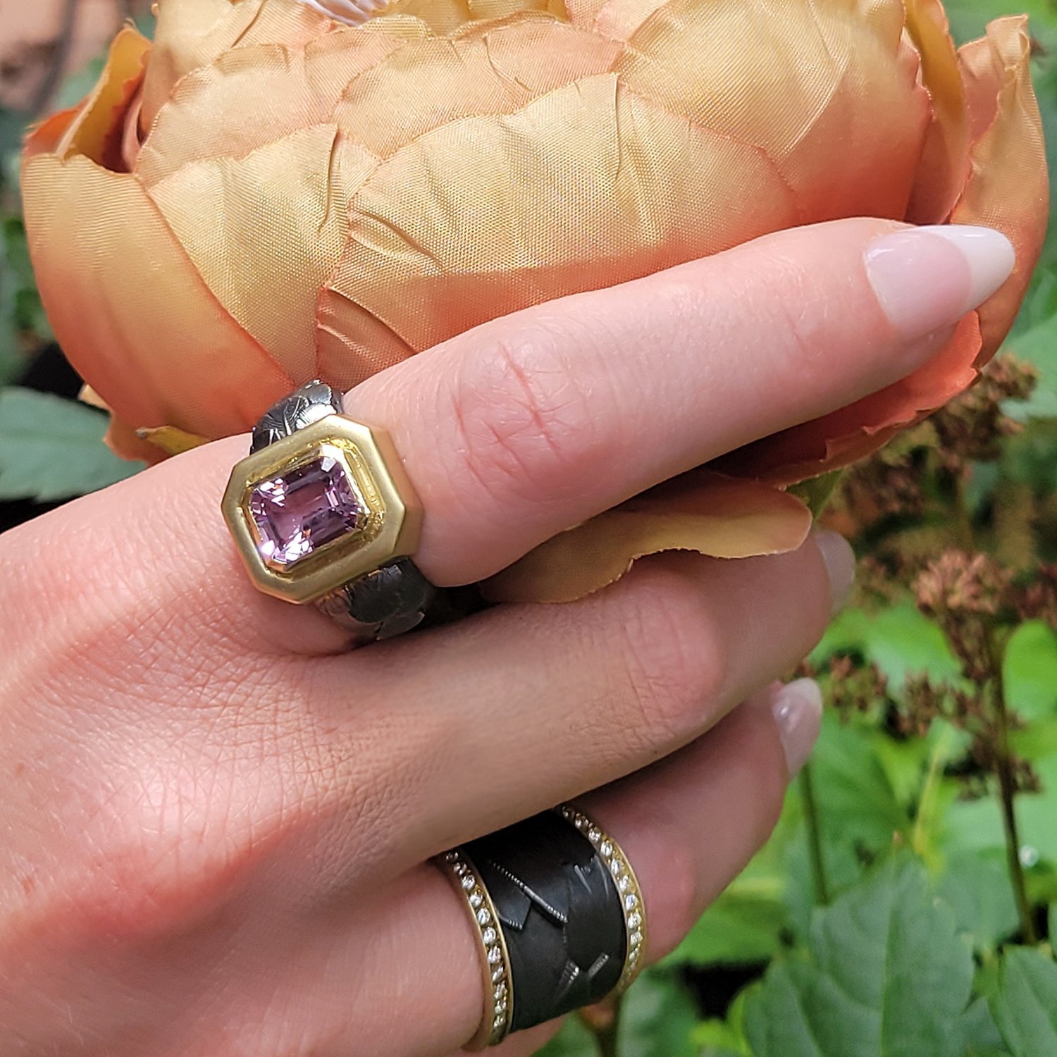 Kunzite feather ring and wide oxi feather band with diamond edges. 1k yellow gold, kunzite, pave set diamonds. Lifestyle. Handmade fine art jewelry by Rebecca Myers Design.