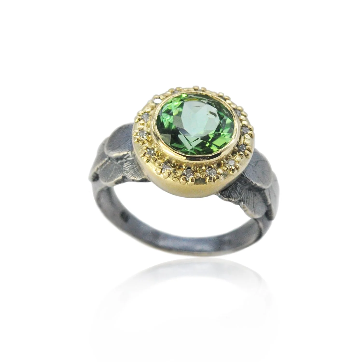Feather Halo Ring with Faceted Mint Tourmaline. Mint tourmaline, 14k yellow gold, oxidized silver, pave set white diamonds. Handmade fine art jewelry by Rebecca Myers Design.