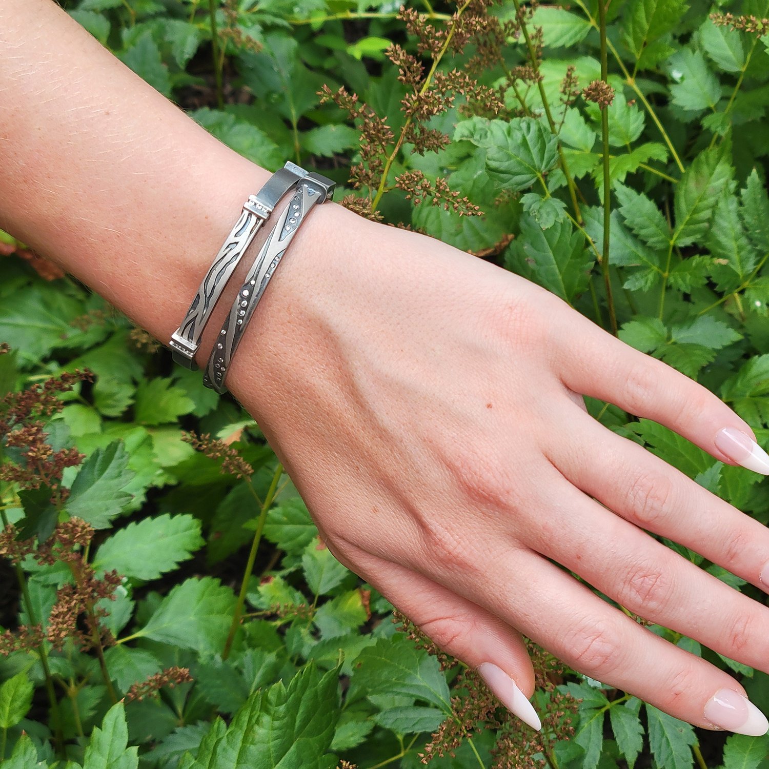 Zebra Print Bracelets. Palladium, oxidized silver, white diamonds. Shown here on white female model. Handmade fine art jewelry by Rebecca Myers Design.