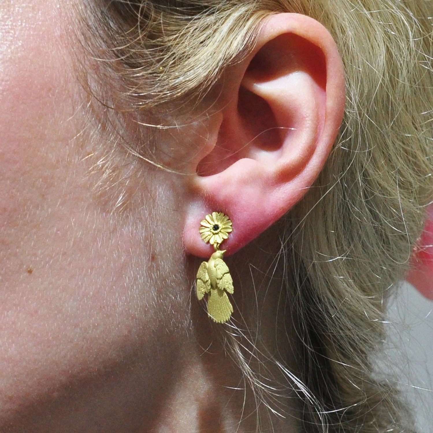 Large Bird with Shasta Topper Earrings. 14k yellow gold, black diamonds. Shown on white female model. Handmade fine art jewelry by Rebecca Myers Design.