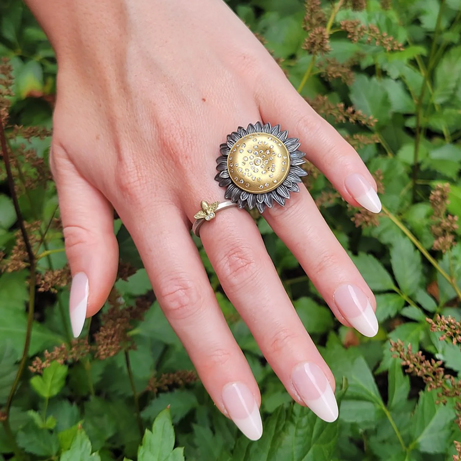 Tiny Bee Ring. 14k yellow gold, silver, tube set diamonds. Shown here on white female model. Handmade fine art jewelry by Rebecca Myers Design.