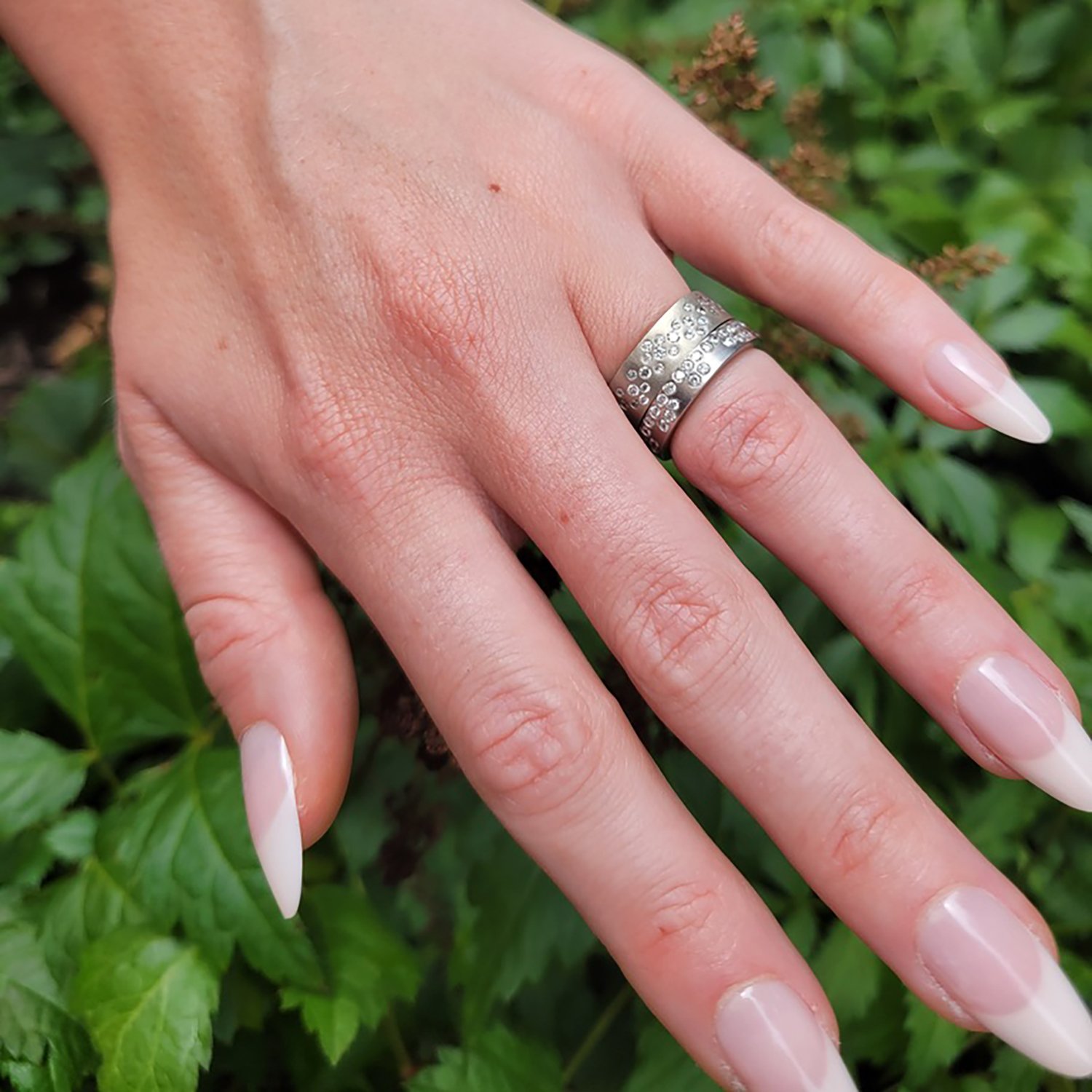 White Gold Fairy Dust Rings. Shown here on white female model. Handmade fine art jewelry by Rebecca Myers Design.