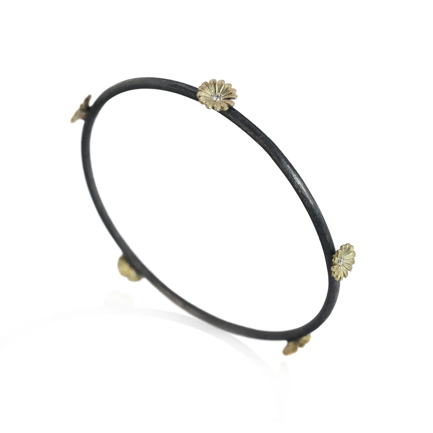 Shasta Daisy Bangle. Shasta Daisy Bangles. 14k yellow gold, white diamonds, oxidized silver. Bracelet on white background. Handmade fine art jewelry by Rebecca Myers Design.