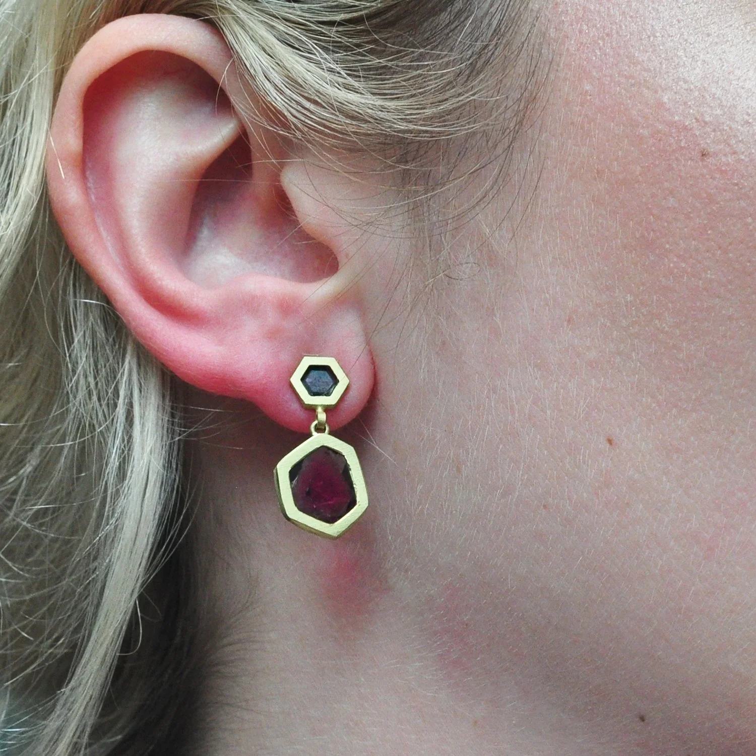 Hex Dia Topped Ruby Slice Earrings. 14k and 18k yellow gold, grey diamond slices, ruby slice. On white female model. Handmade fine art jewelry by Rebecca Myers Design.