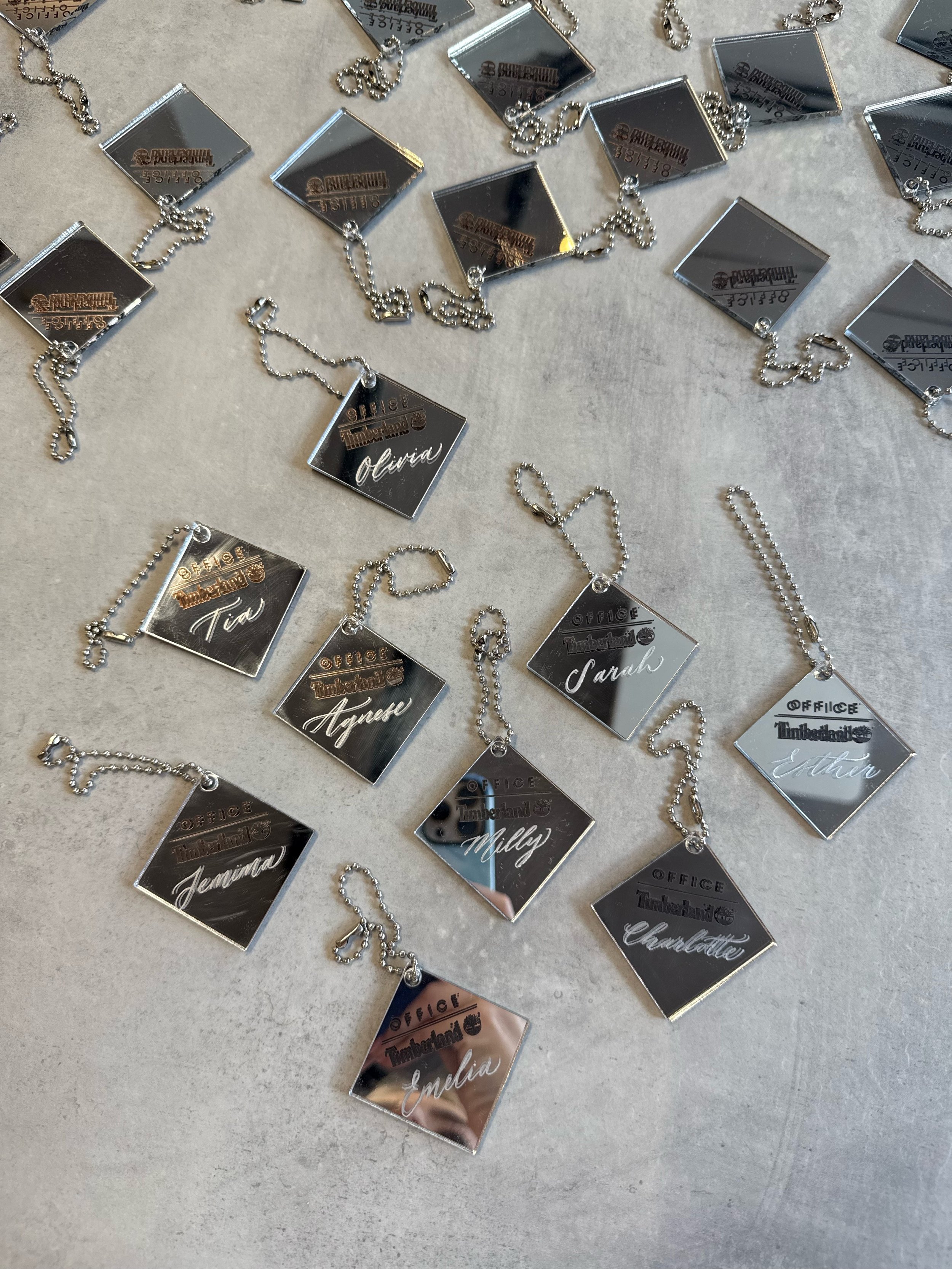 Engraving Timberland branded metal boot tags for an exclusive content creator event. Live engraving for OFFICE shoes and Timberland brand activation. Calligraphy engraving on metal.