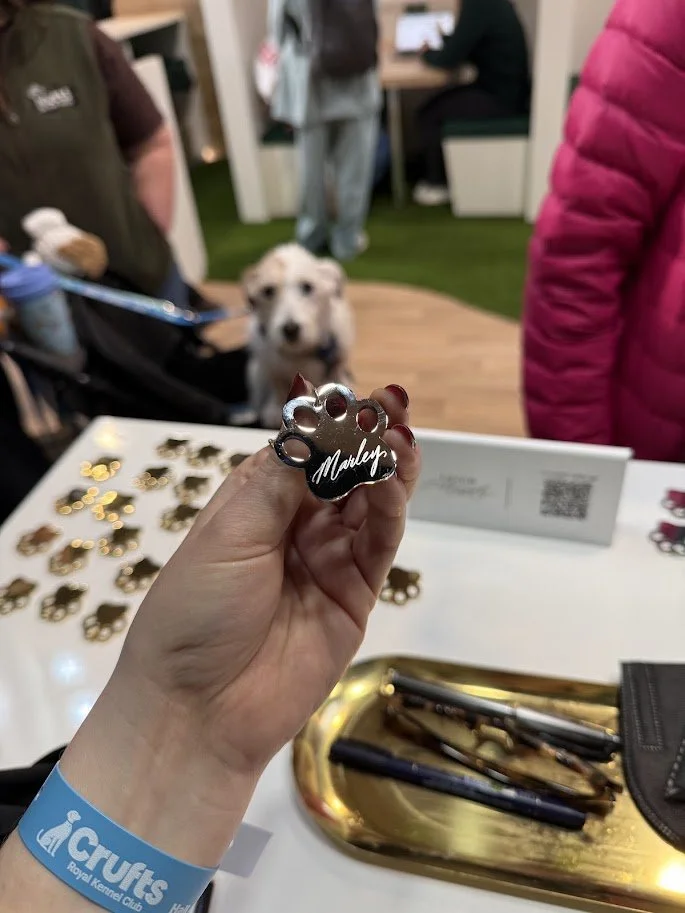 Engraving metal dog collars for customers at Crufts dog show 2026