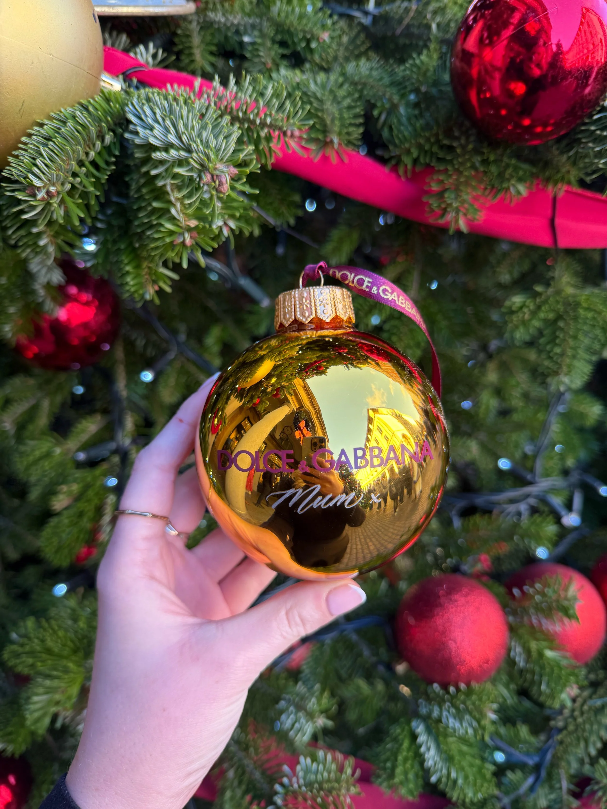 Hand engraved gold christmas bauble for luxury brand activation. Dolce and Gabbana live engraving