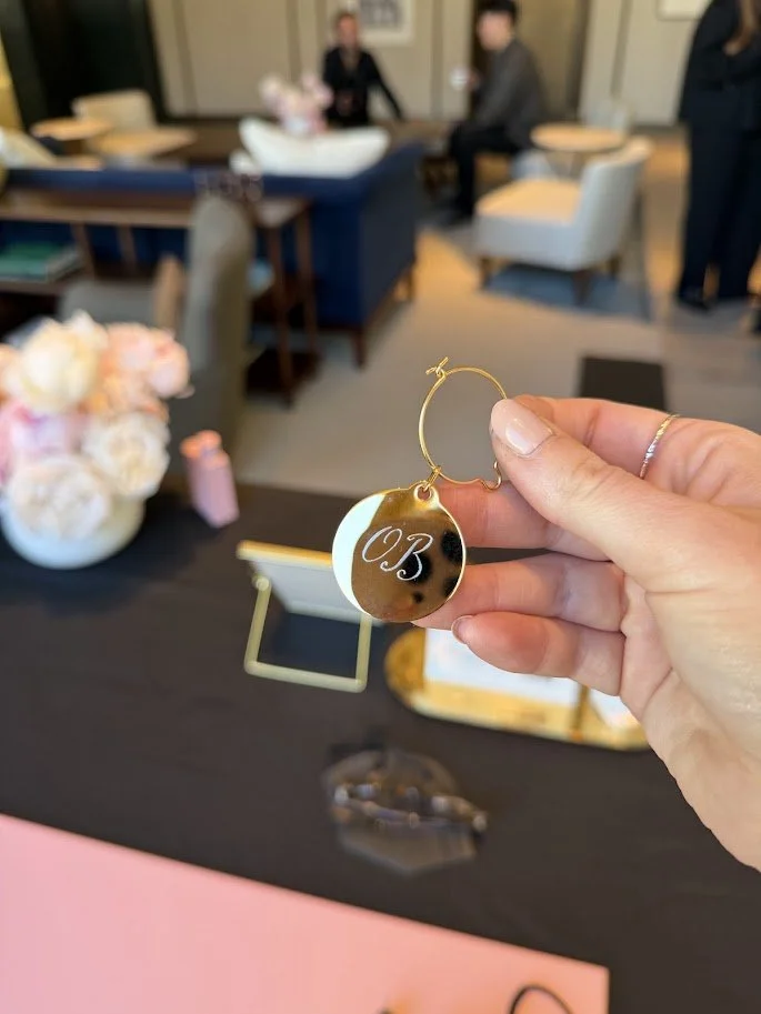 engraving metal perfume disks at a Burberry brand activation at the The Chancery Rosewood