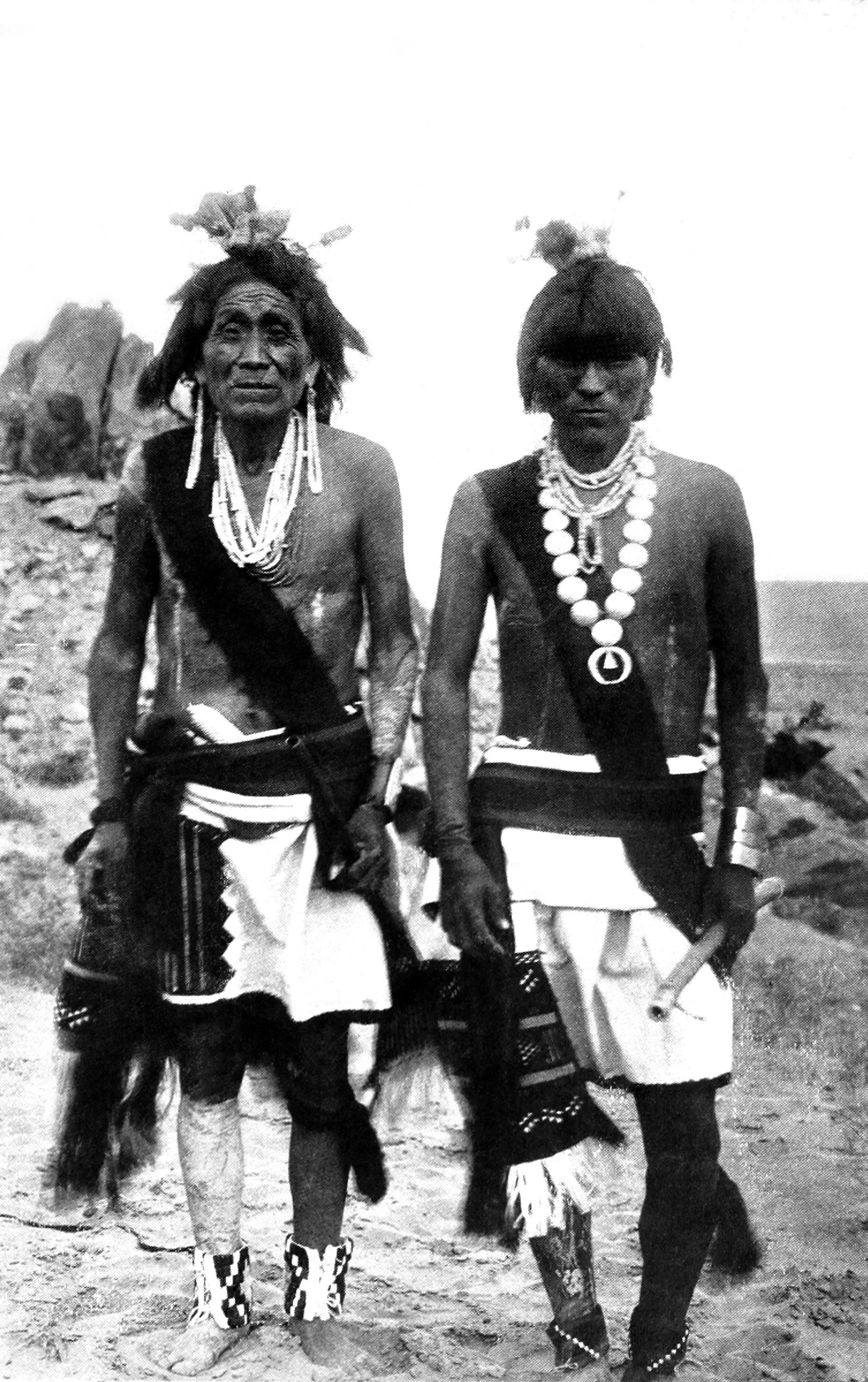 Two Flute priests in full costume