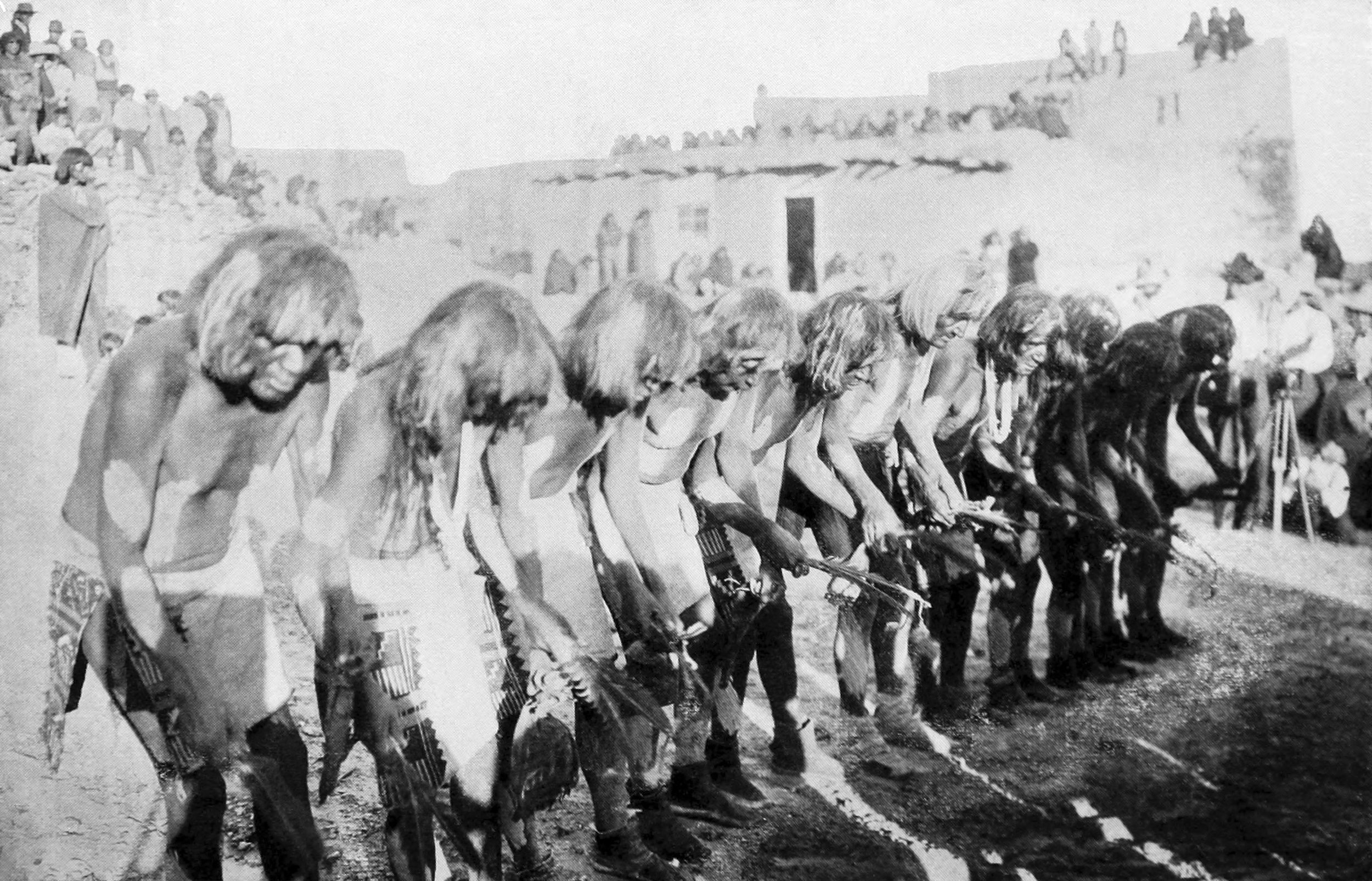 The Snake dancers in the act of making certain sideways motions with their hands, to which they hum a song in a low tone (eighth day)