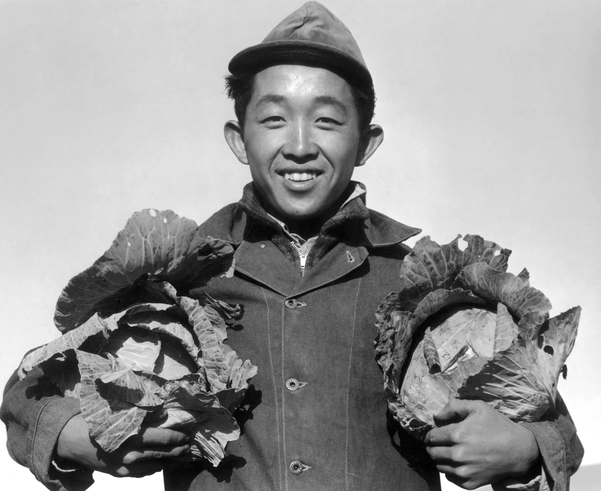 Richard Kobayashi, farmer with cabbages, Manzanar Relocation Center, California