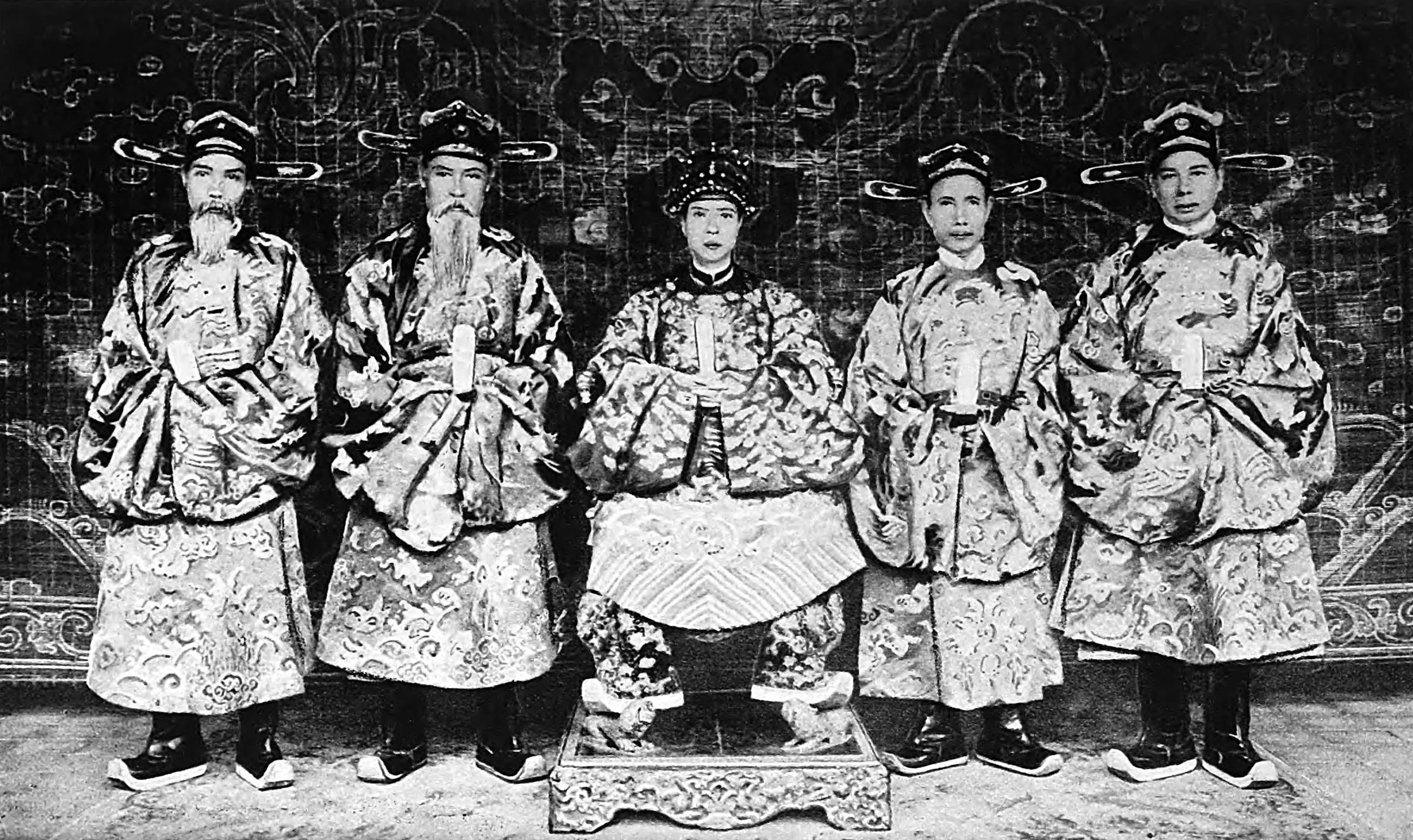 Here is the Emperor enthroned between the Four Columns of the Kingdom-Justice, Education, Treasury, and Public Works