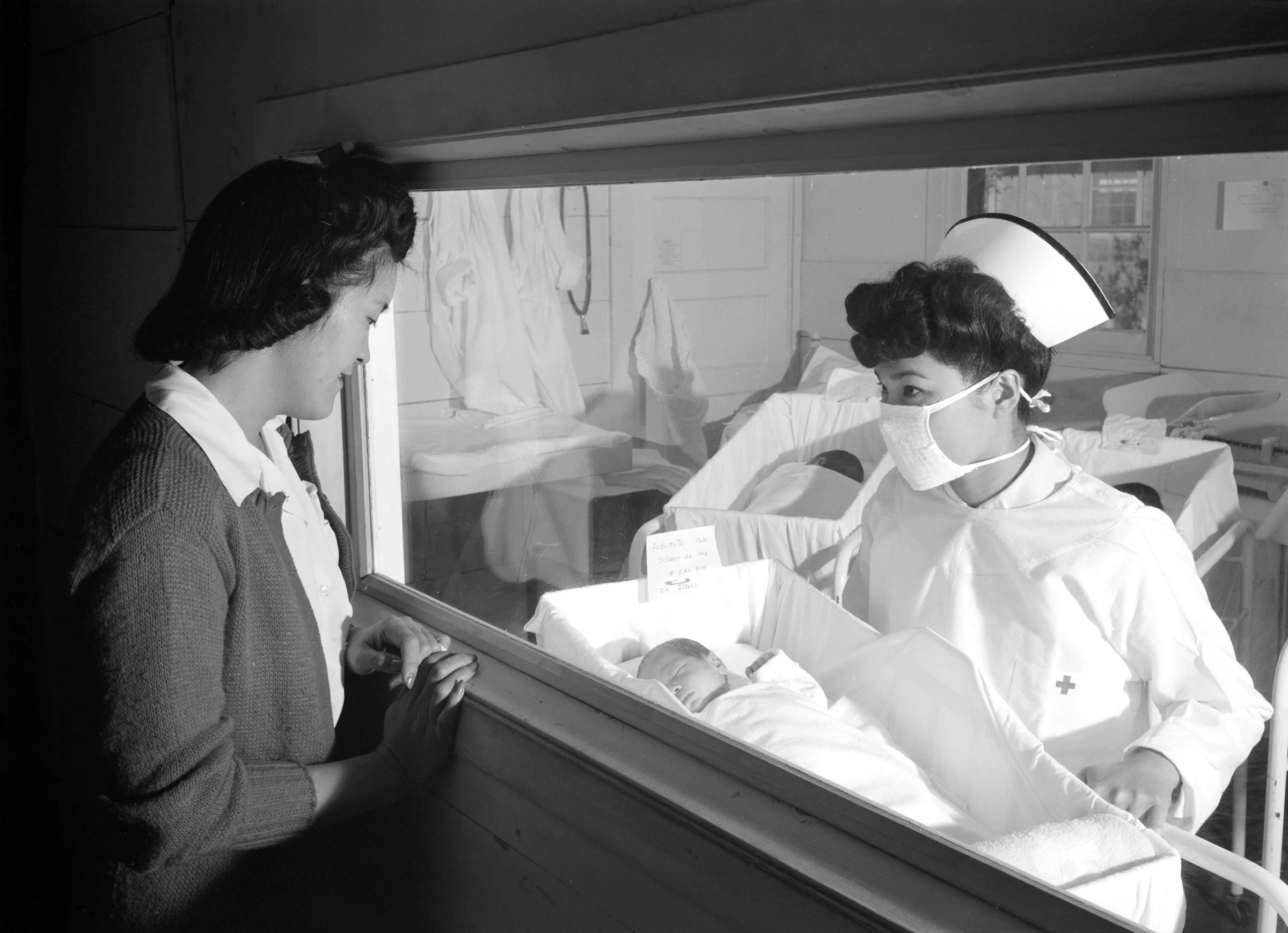 Nurse Aiko Hamaguchi, mother Frances Yokoyama, baby Fukomoto, Manzanar Relocation Center, California