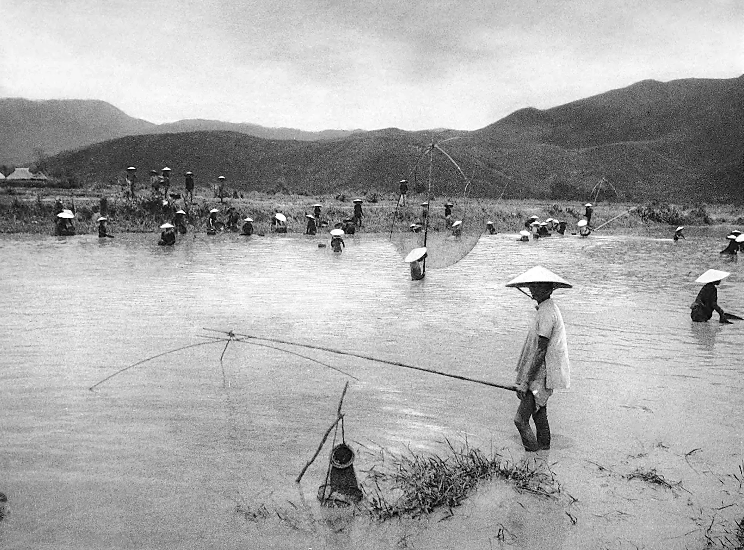 Fisherman on a lake in Annam
