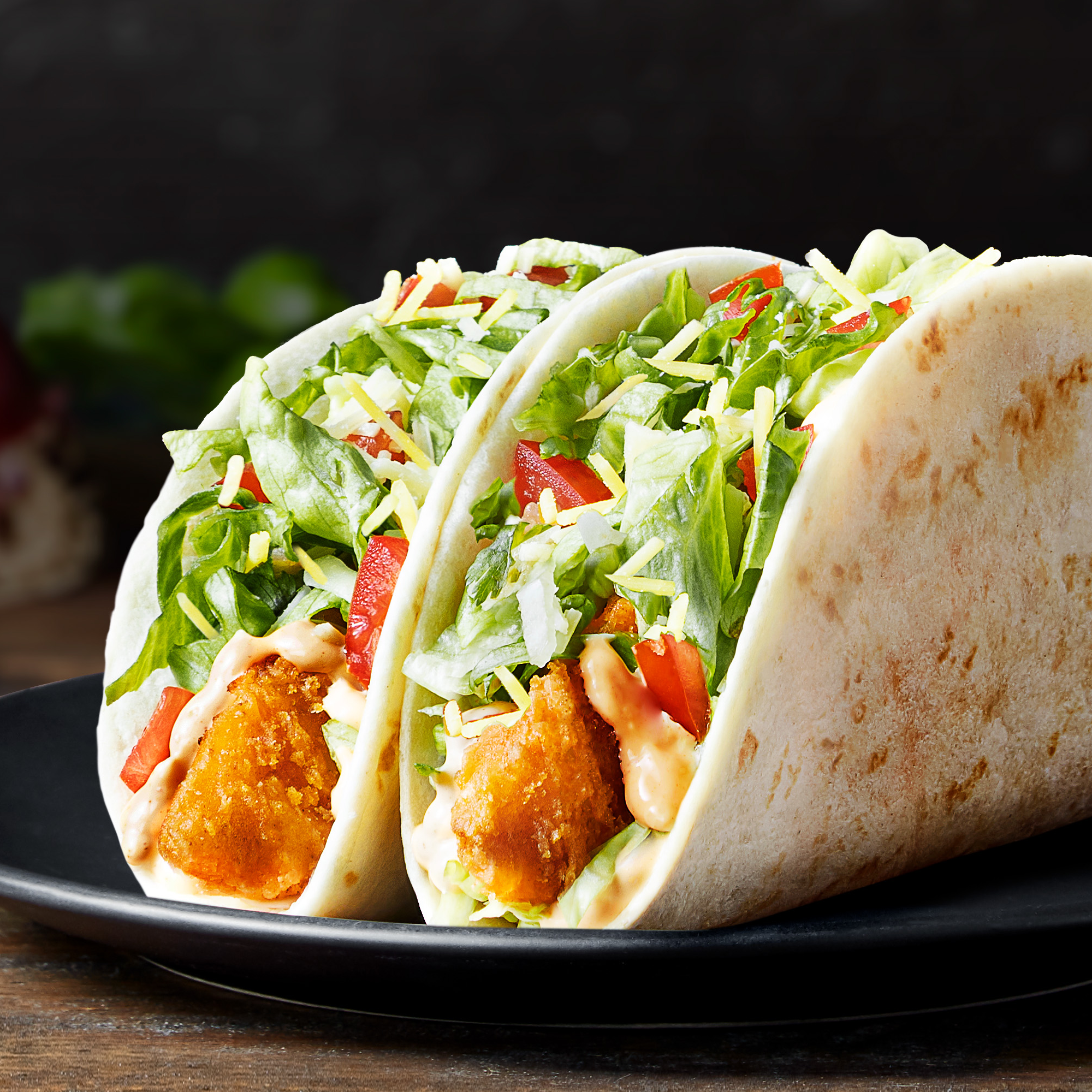 DOUBLE CRISPY CHICKEN TACO  Filled with a crispy chicken strip, creamy chipotle sauce, shredded iceberg lettuce, fiesta salsa and topped with 2 cheese blends. It’s a delicious combination of soft and crispy.