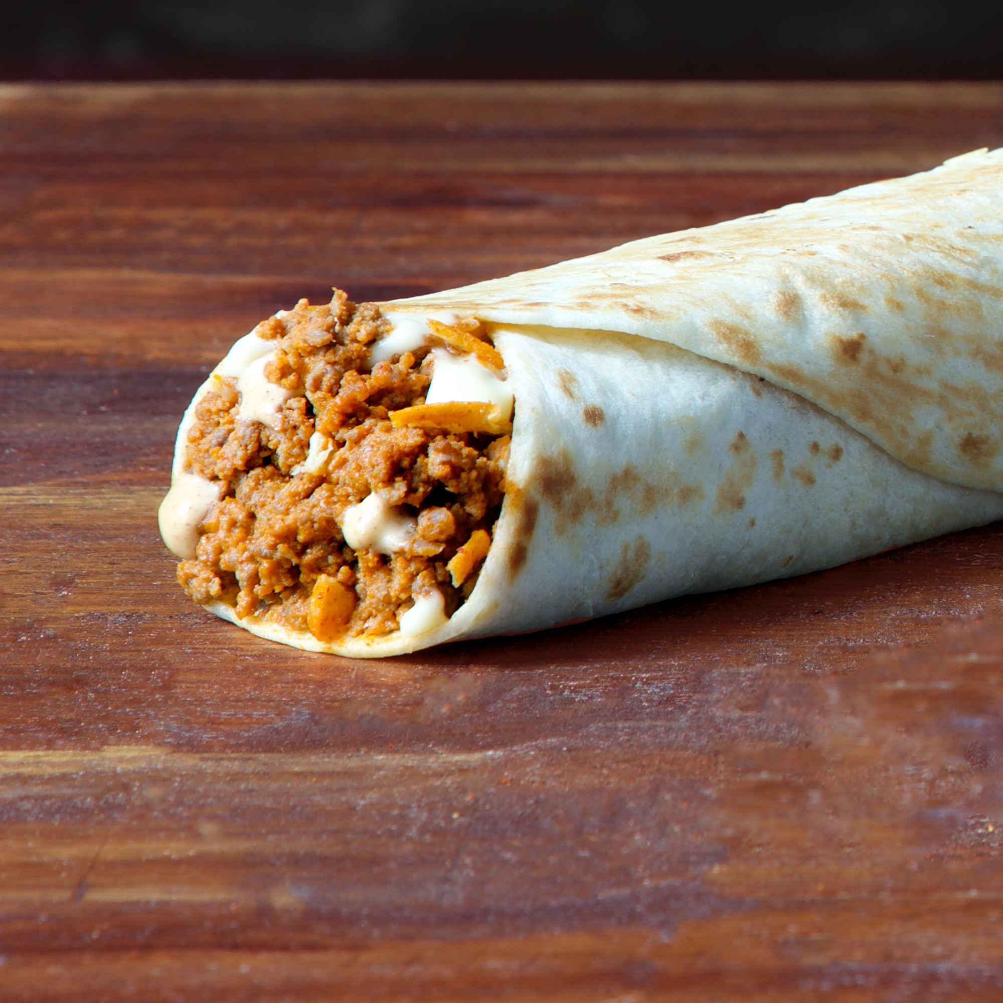 bEEFY cHEESE BUrrito  Looking for something crunchy to snack into? It is a soft tortilla with seasoned beef, warm nacho cheese sauce, creamy jalapeno sauce &amp; crunchy nachos to give the perfect bite.