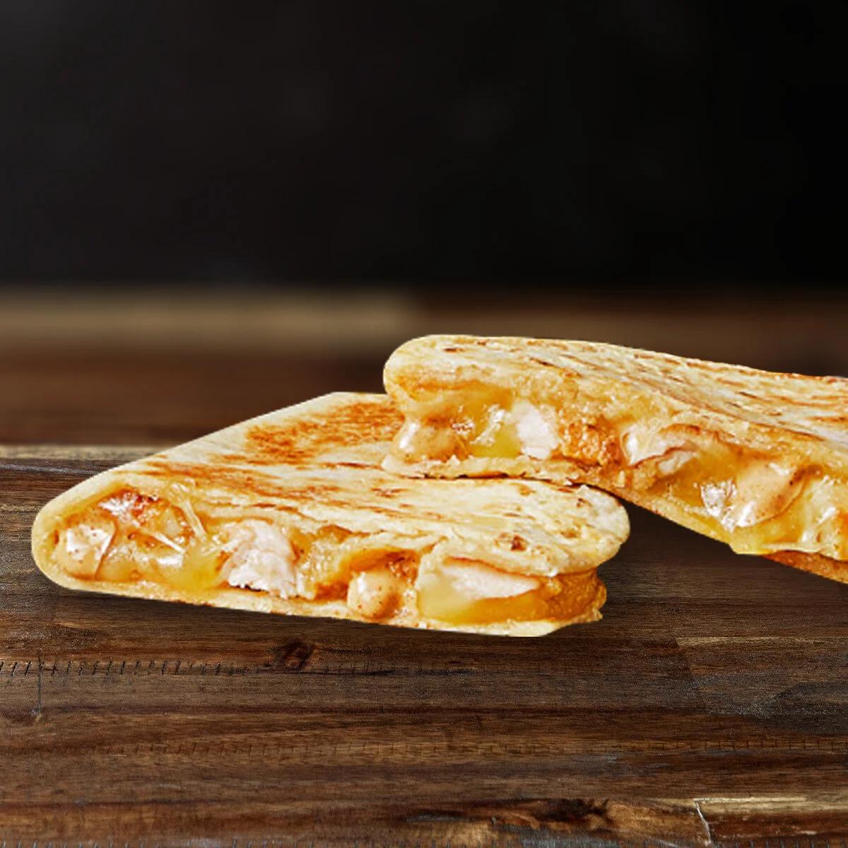 MINI CHICKEN QUESADILLA  Grilled soft tortilla filled with melted cheese, creamy jalapeno sauce and chicken. Good things come in small packages.