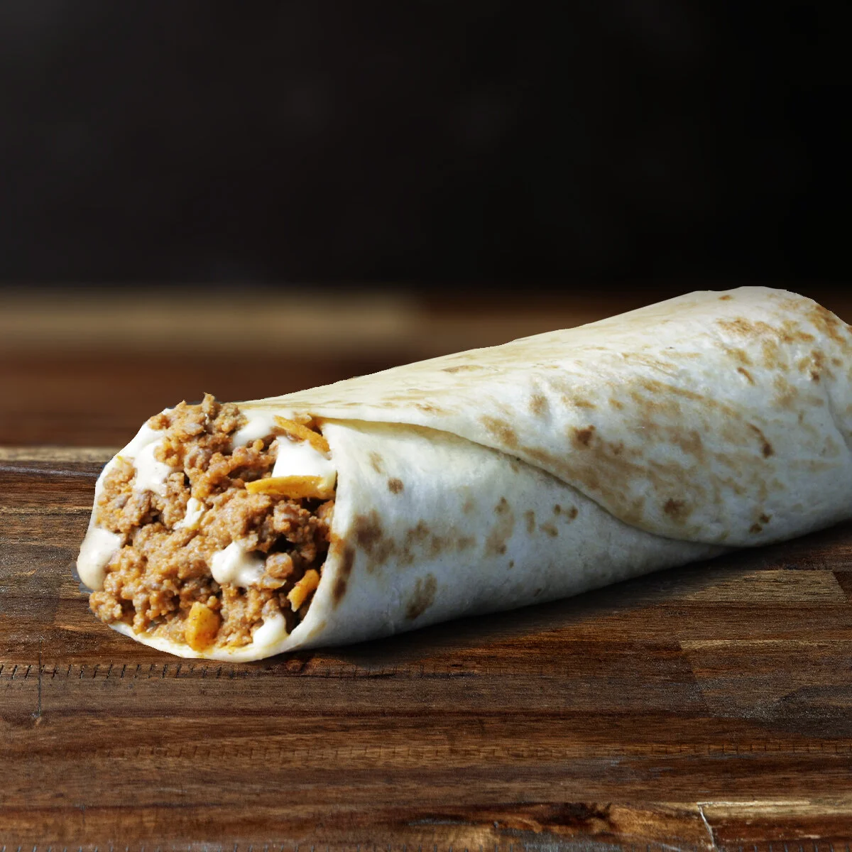 bEEFY cHEESy BUrrito  Looking for something crunchy to snack into? It is a soft tortilla with seasoned beef, warm nacho cheese sauce, creamy jalapeno sauce &amp; crunchy nachos to give the perfect bite.